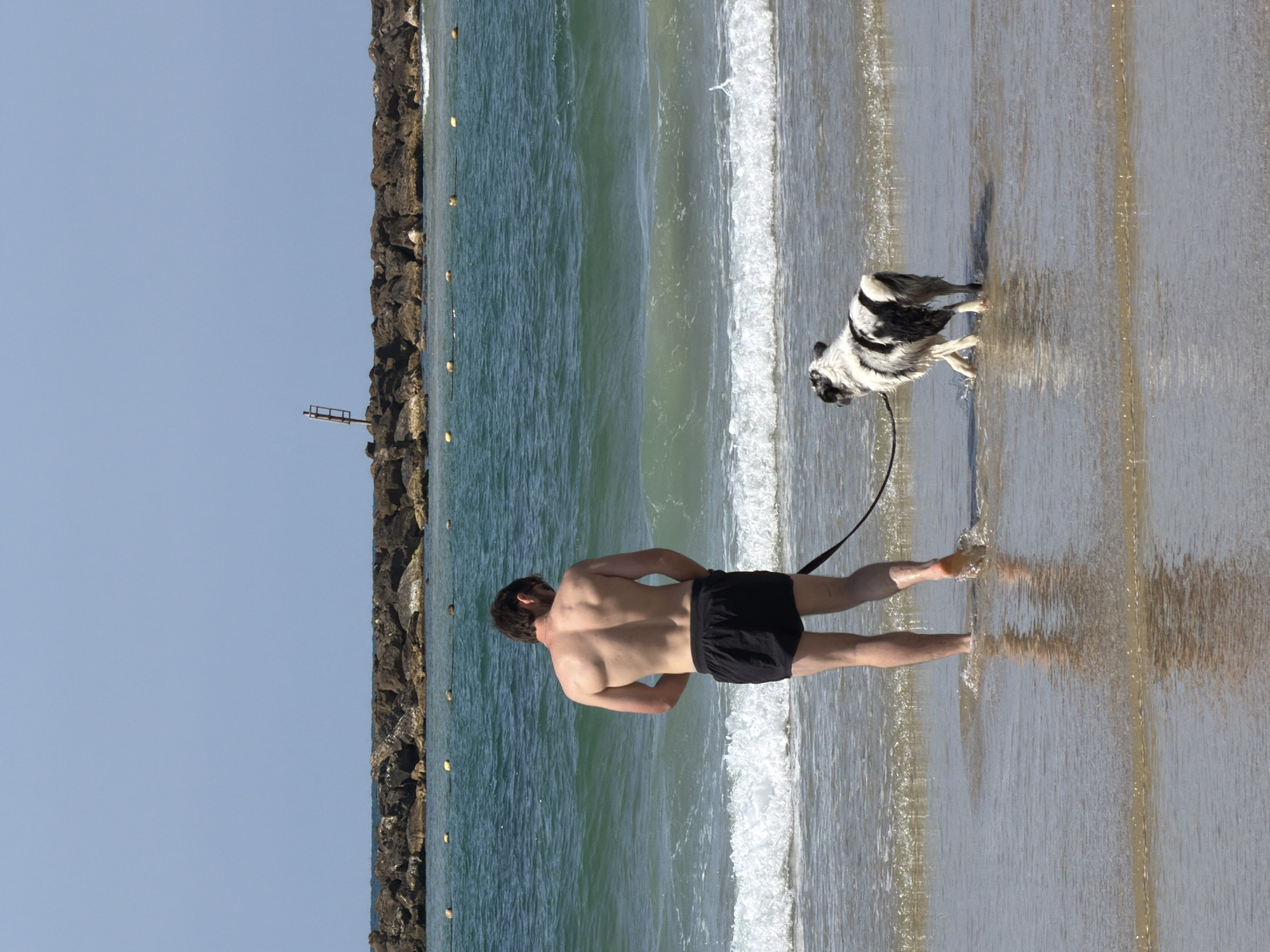 Woman sunbathes on Tel Aviv beach Monday morning