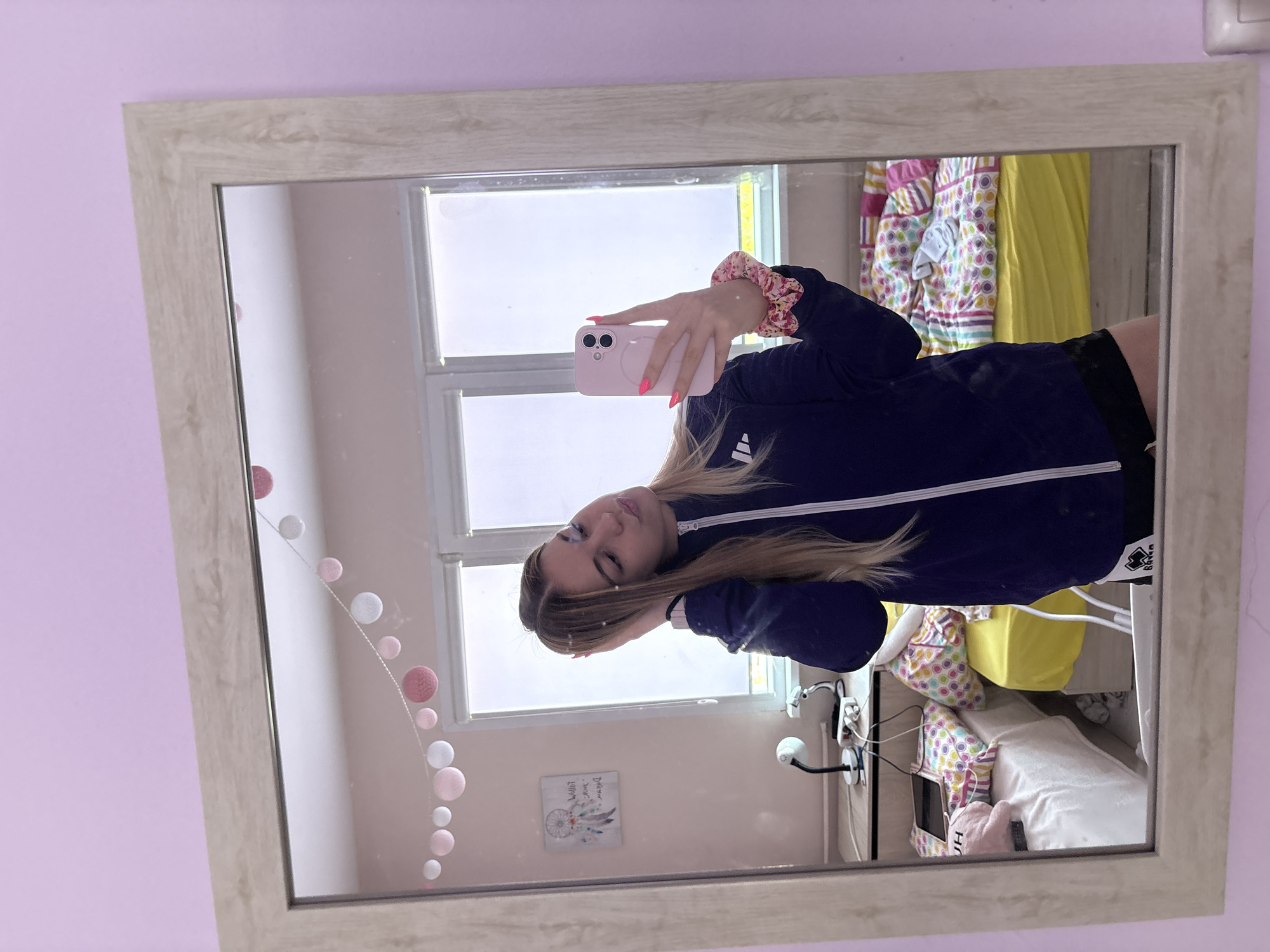 Woman takes mirror selfies in Sofia bedroom Friday morning