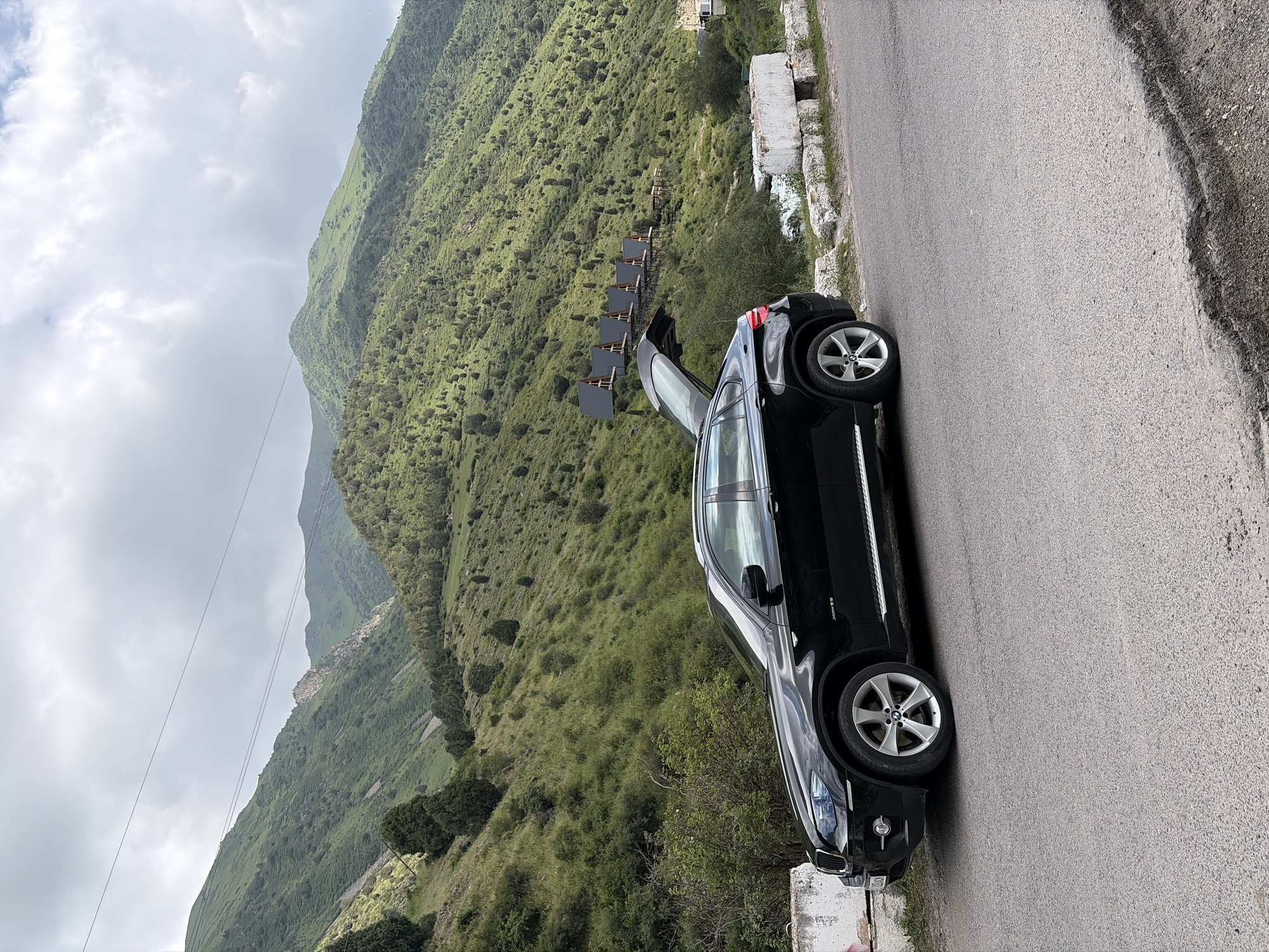 Travelers make roadside stop for water, photos in mountains