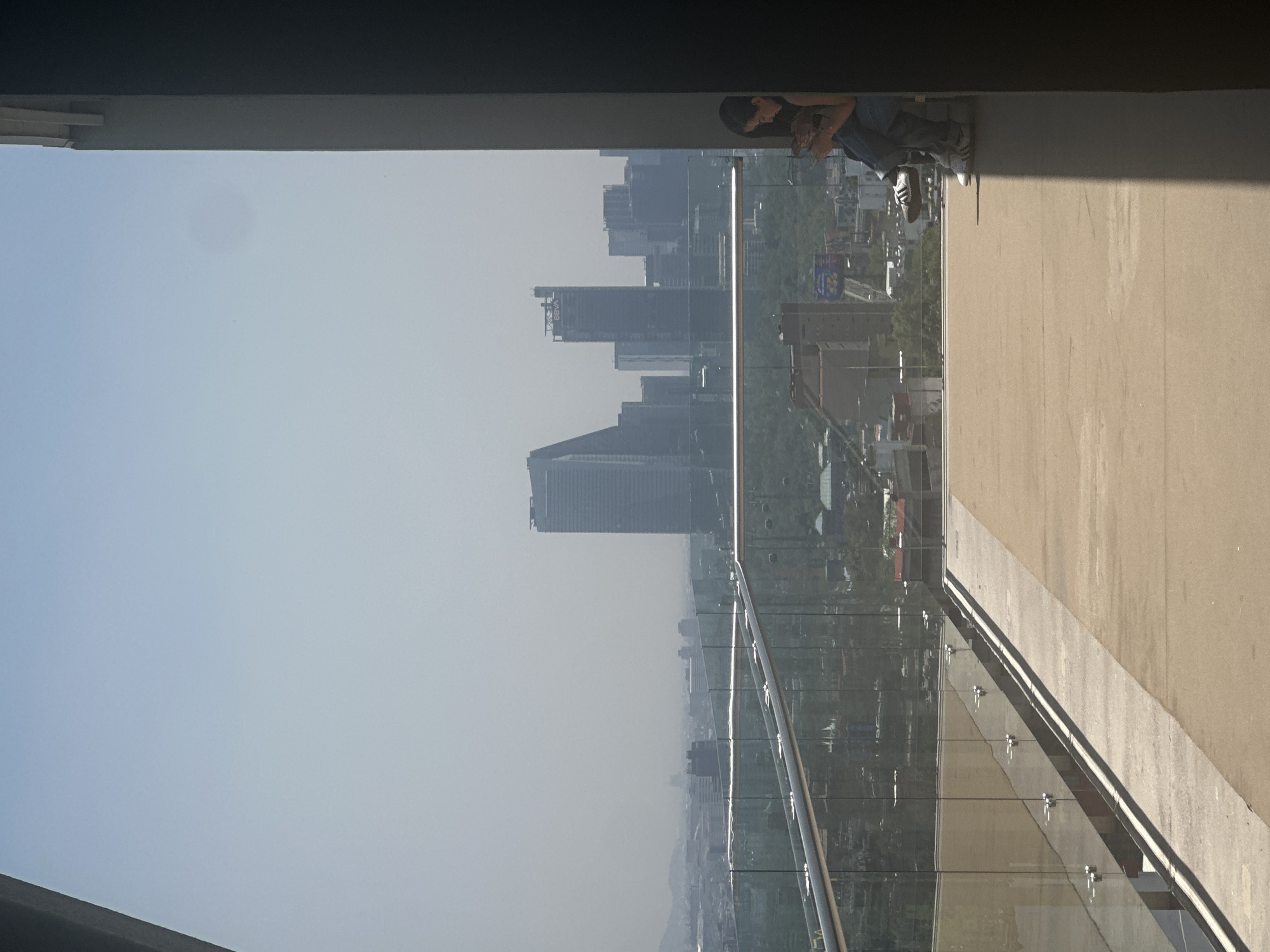Visitors document exhibits and city views at Mexico City cultural venue