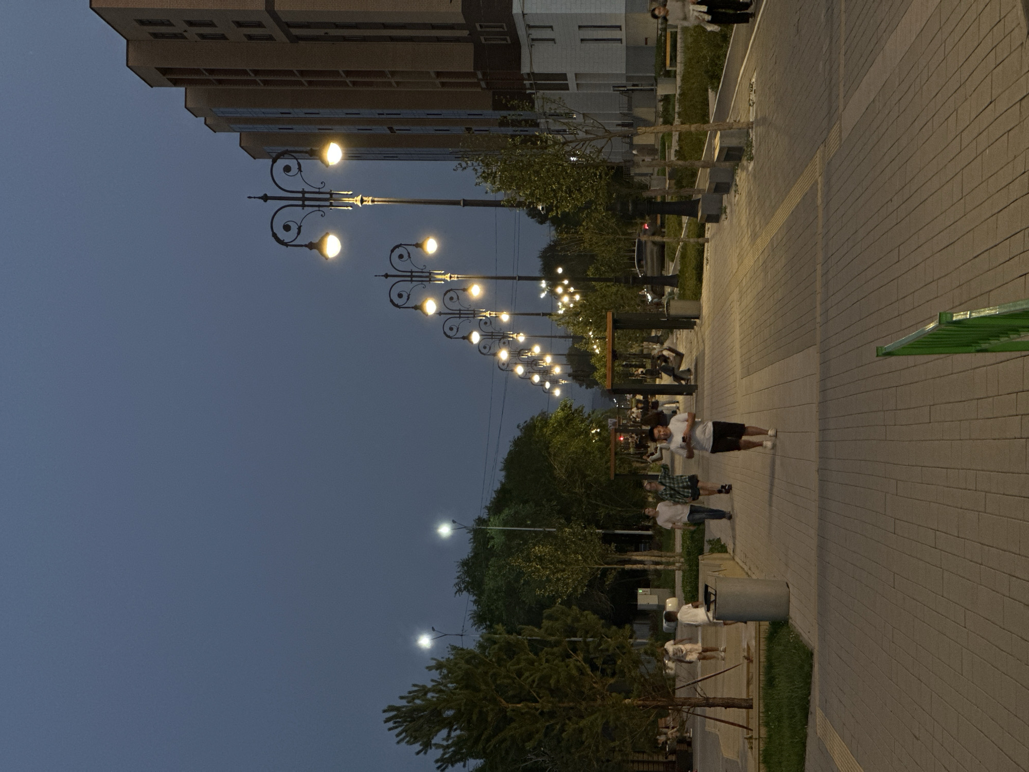Kokshetau at dusk: lit promenade and hillside city sign