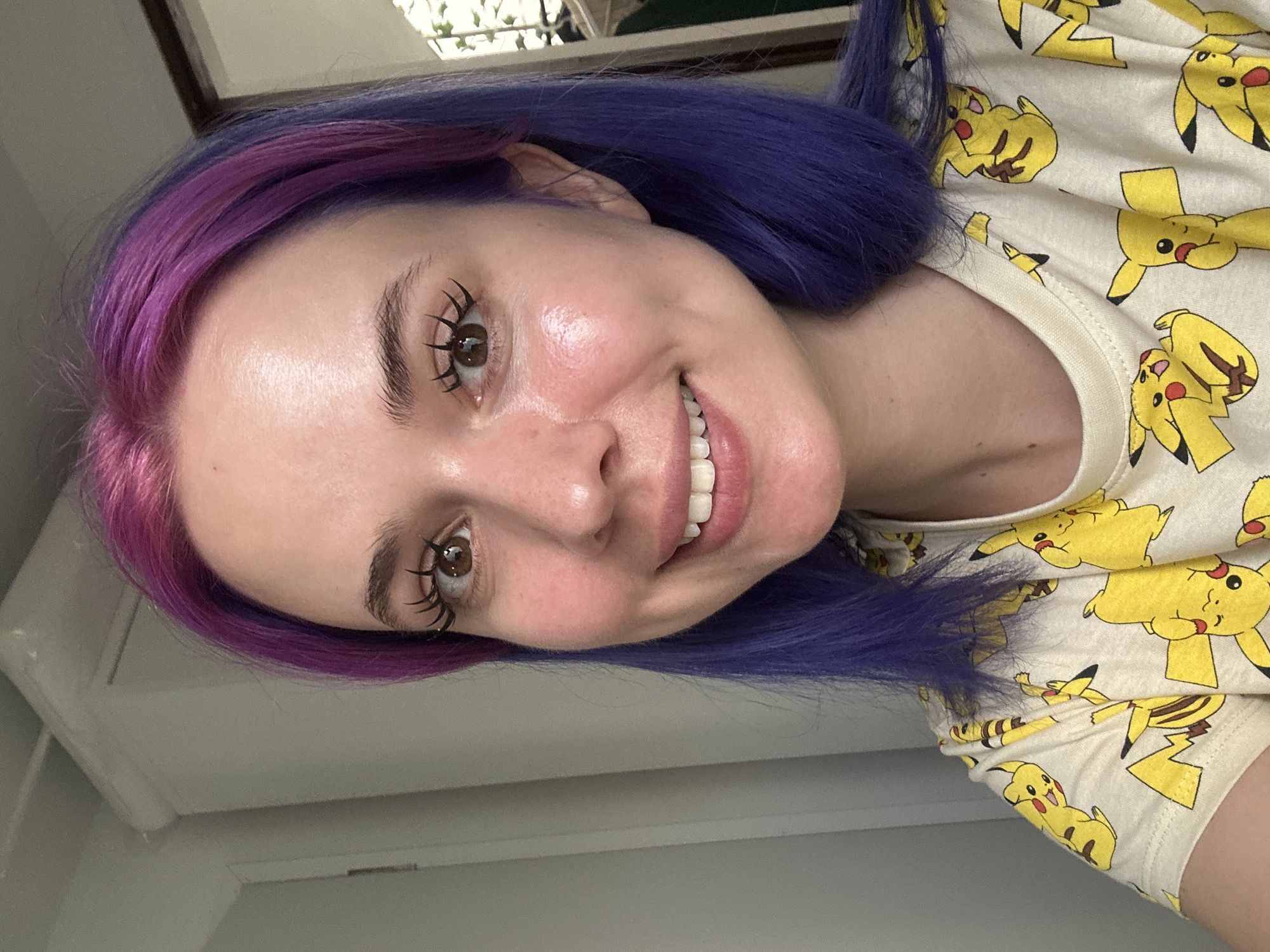 Woman with purple hair poses in Pikachu shirt in Zagreb
