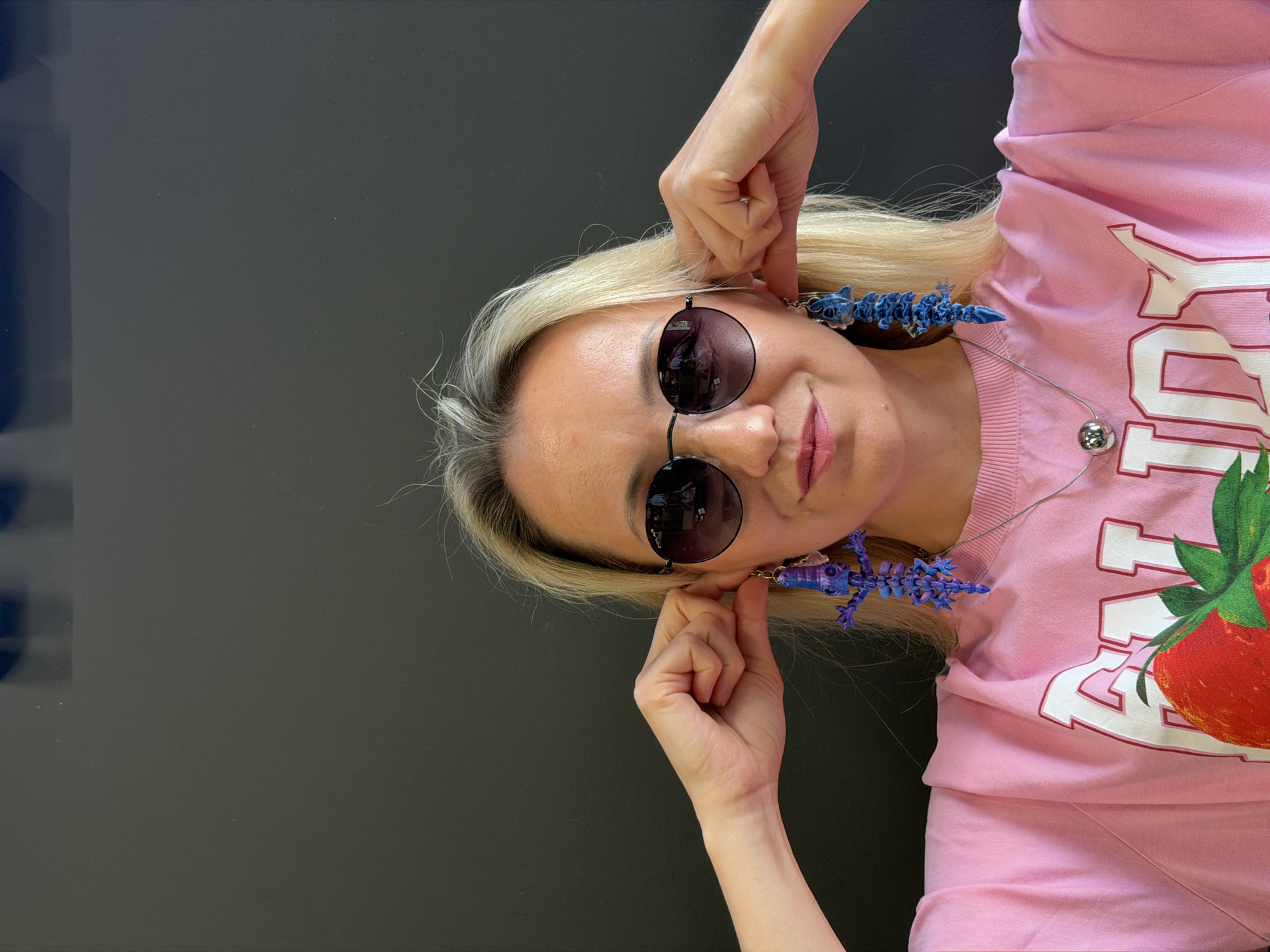 Trying on big blue earrings and making faces in Izhevsk