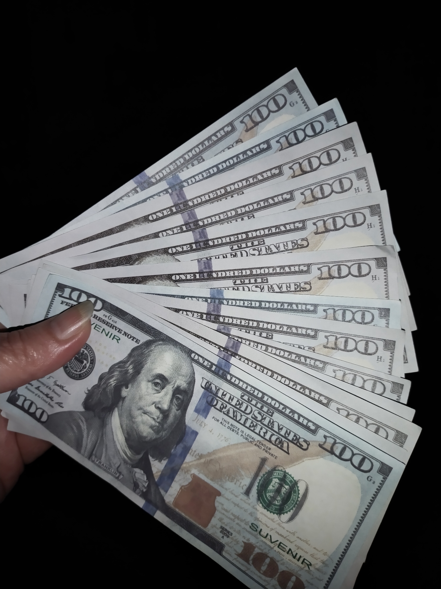Fanned $100 bills displayed in Horishni Plavni