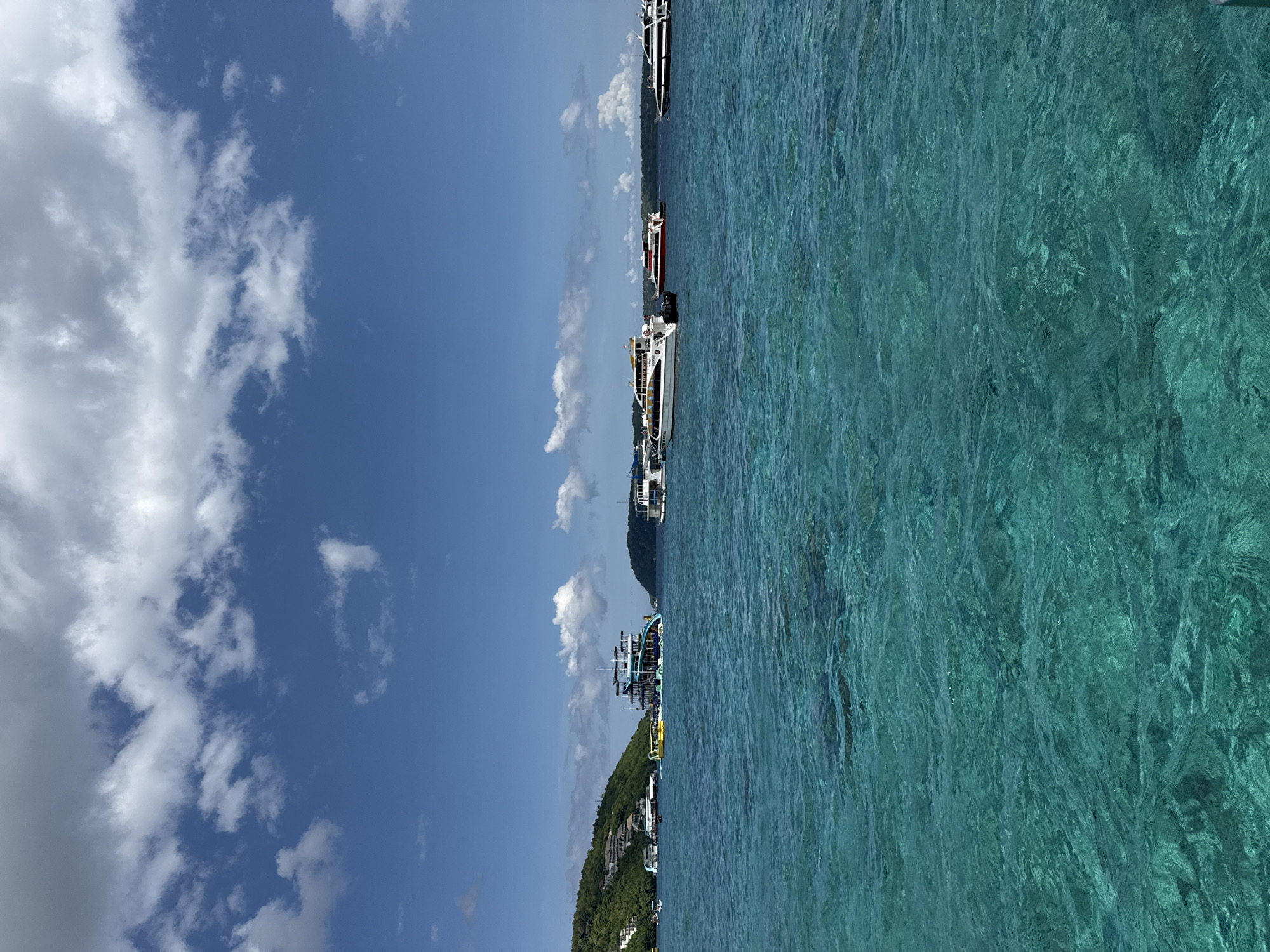 Boats anchored in turquoise waters at Kampung Toyapakeh harbor