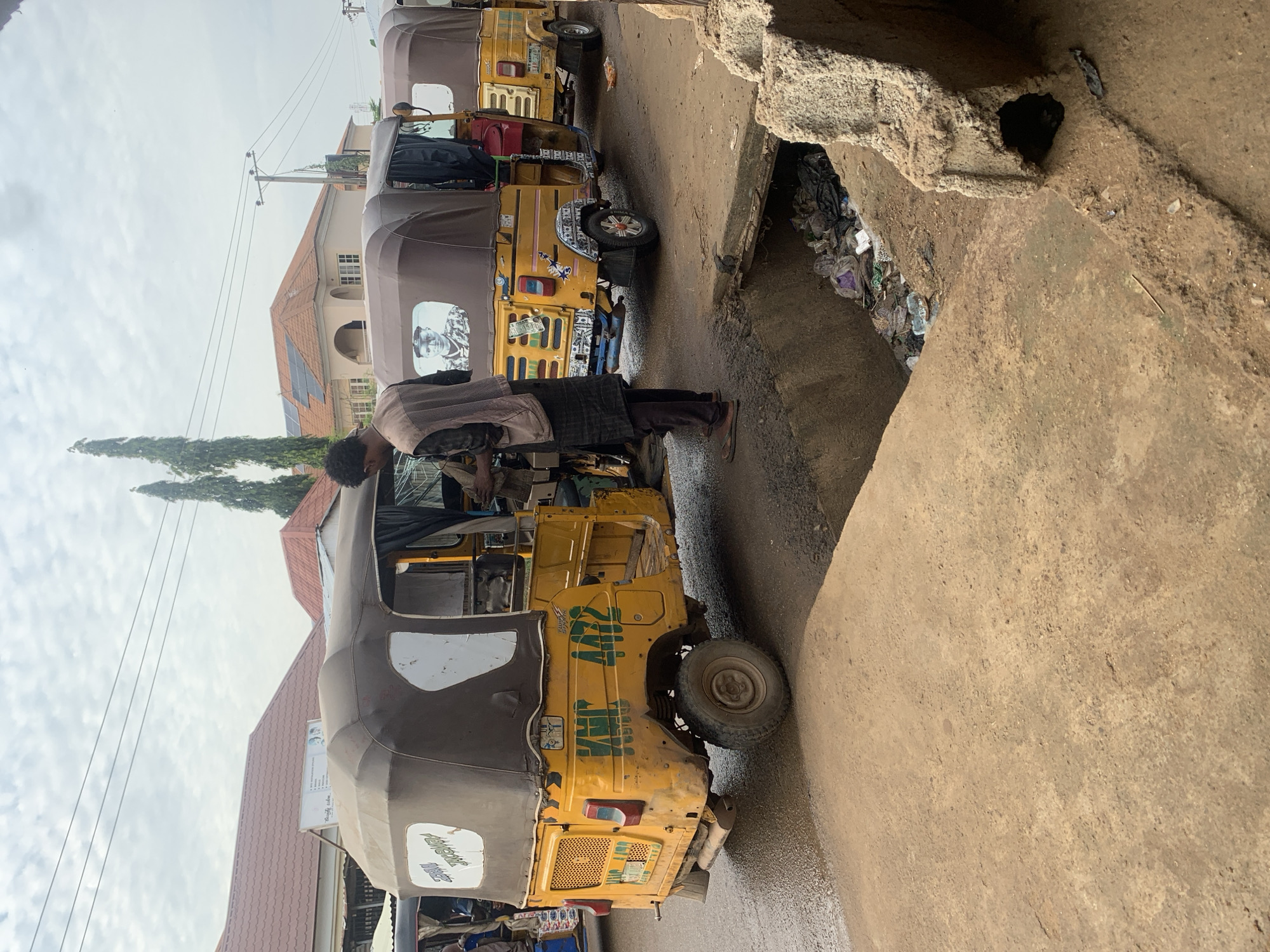 Wet morning street life along a busy Abuja road