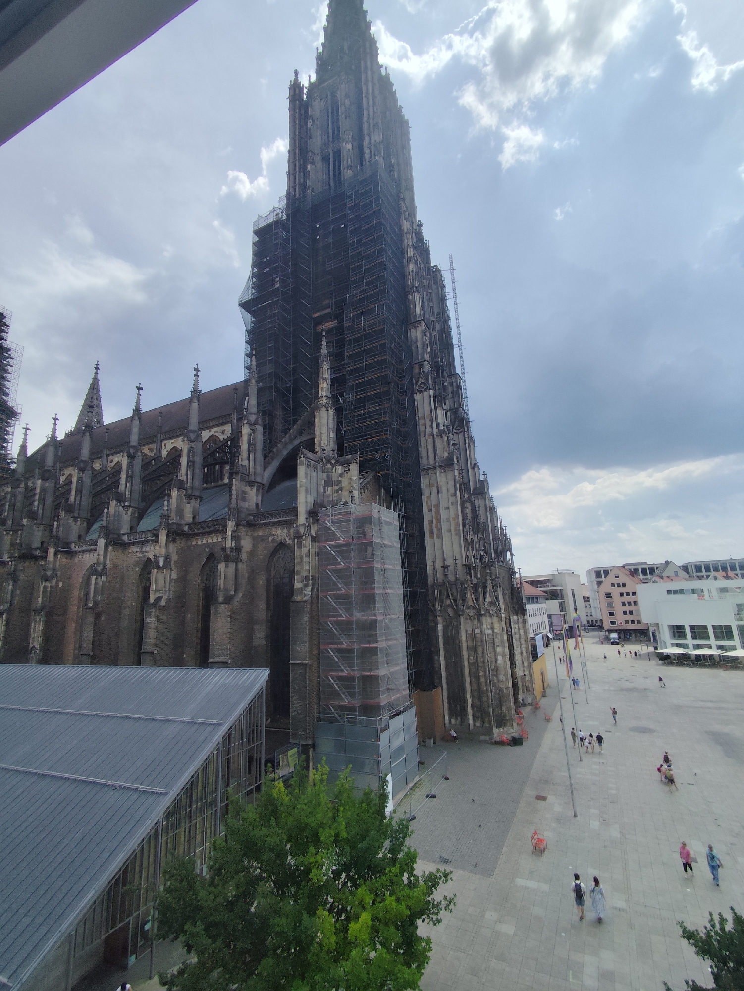 Gothic cathedral mid-restoration, scaffolding covering spires and facade