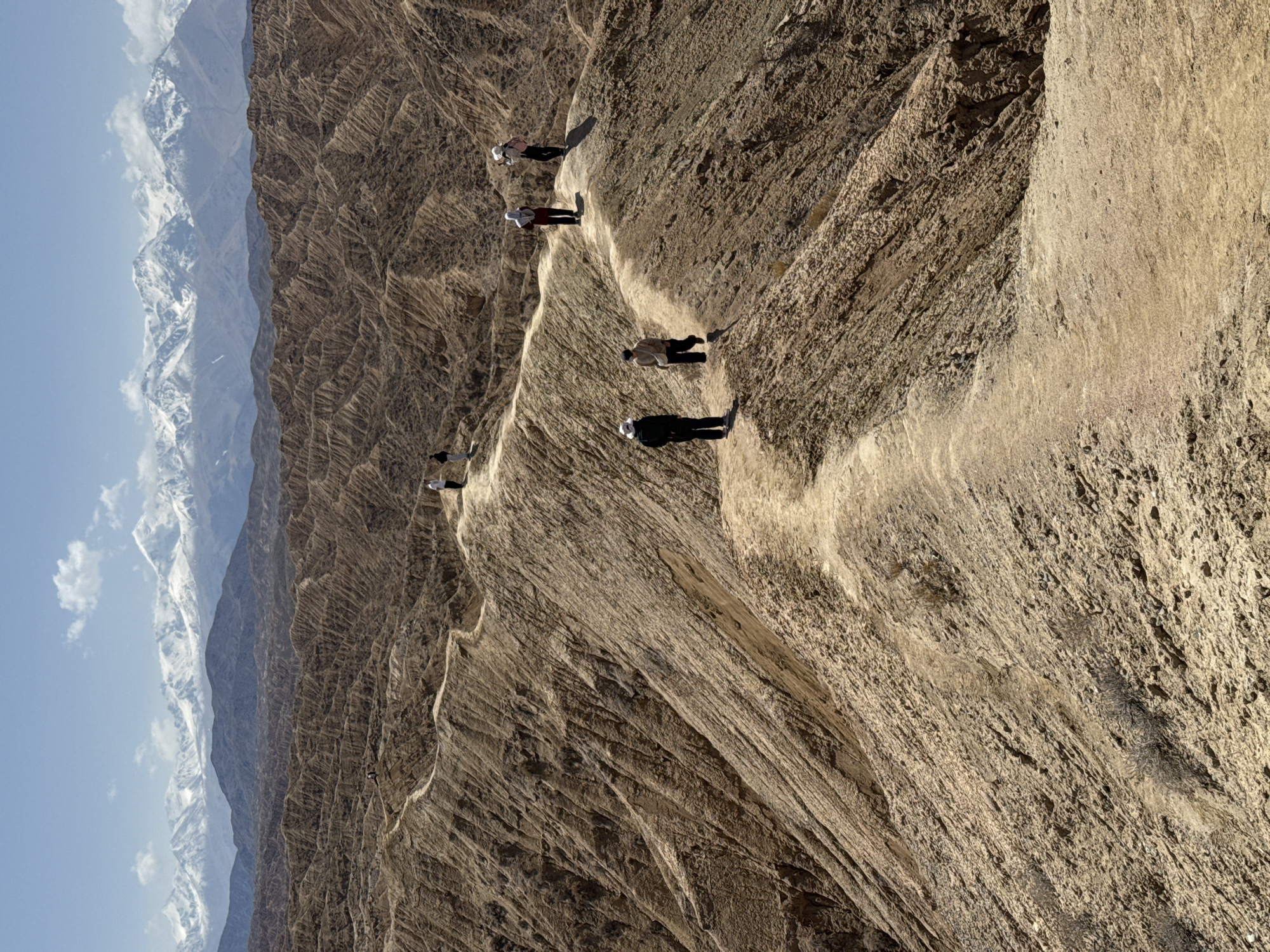 Hikers navigate steep mountain trail in Kyrgyzstan