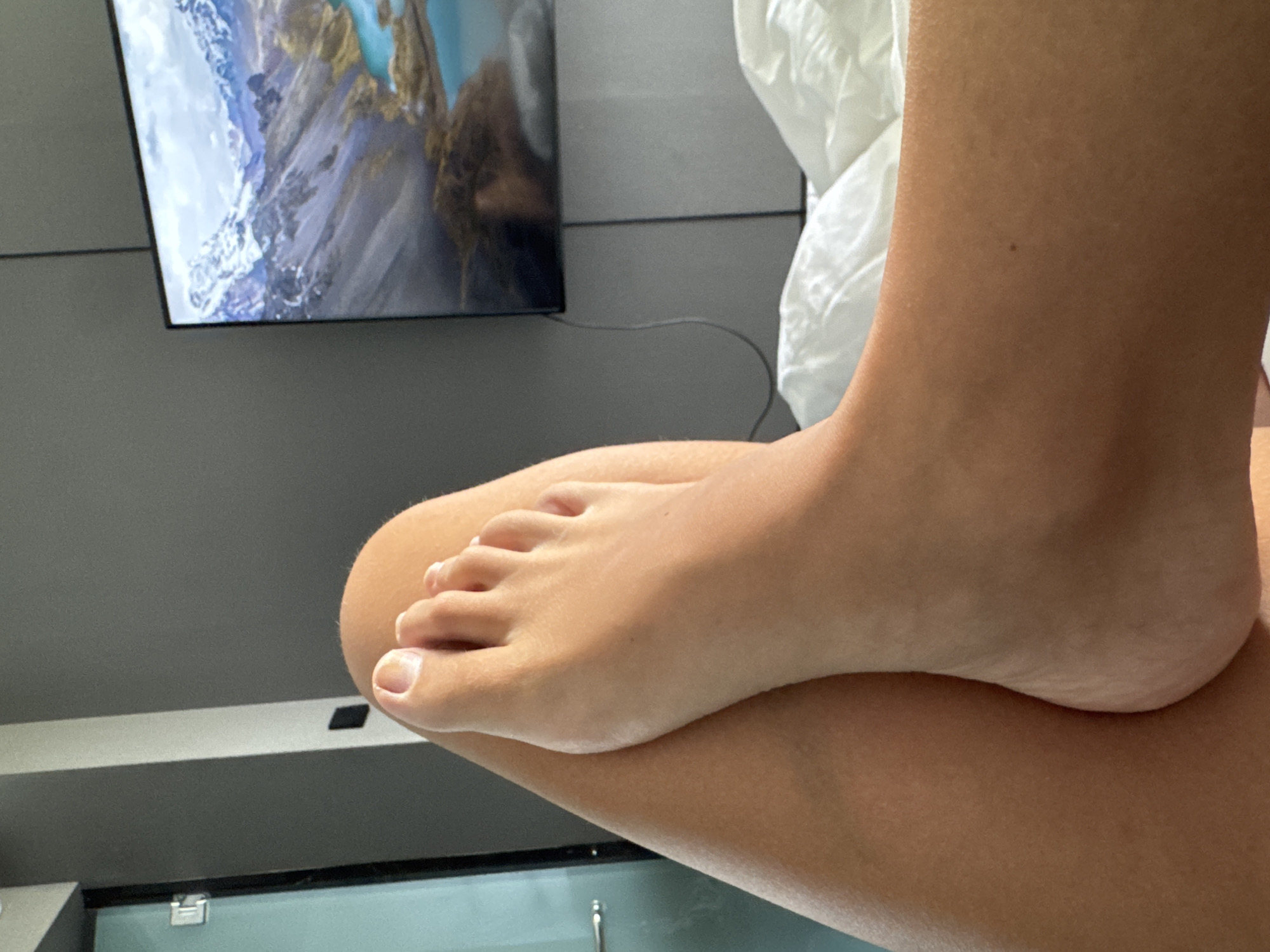 Person's feet photographed indoors in North Kuta, Indonesia