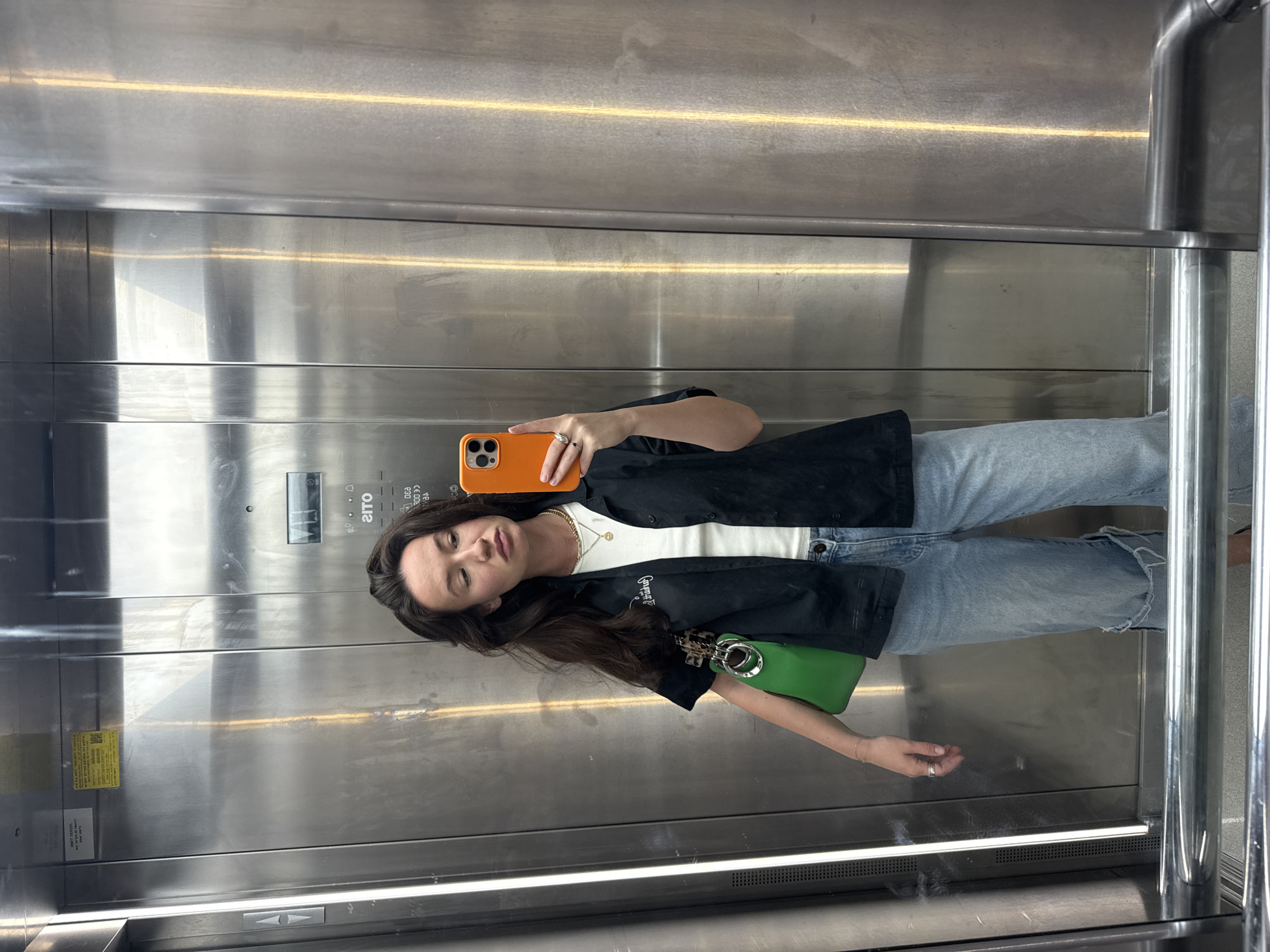 Woman takes elevator selfie in Tel Aviv early morning