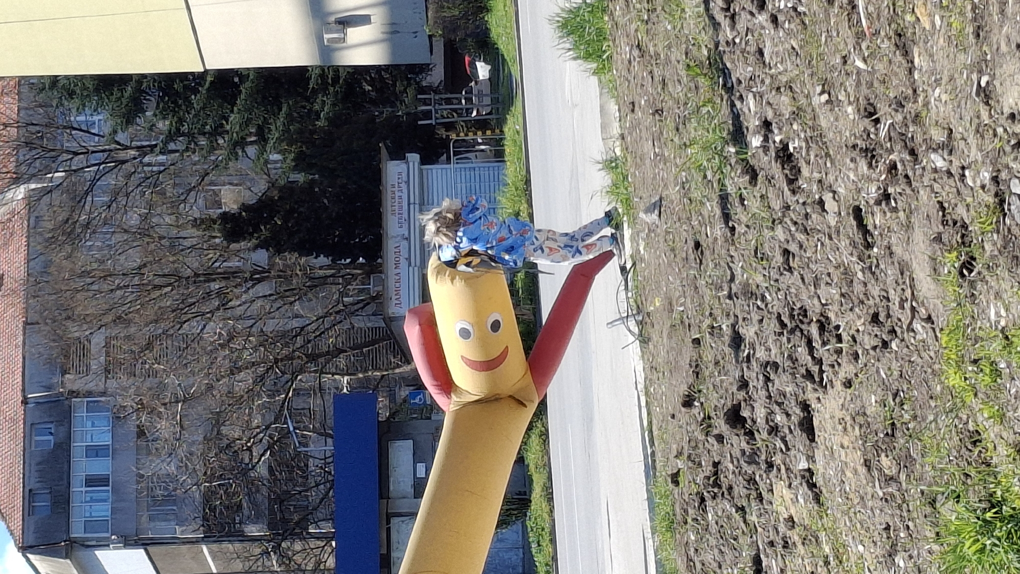 Child plays with inflatable advertising figure in Varna