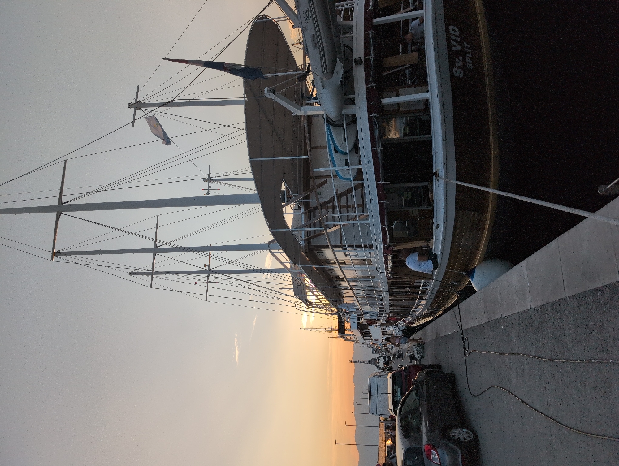 Rijeka marina at sunset, boats docked and people out