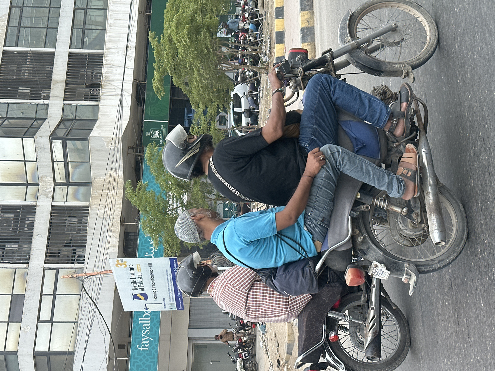 Motorcycles moving through a Karachi city street