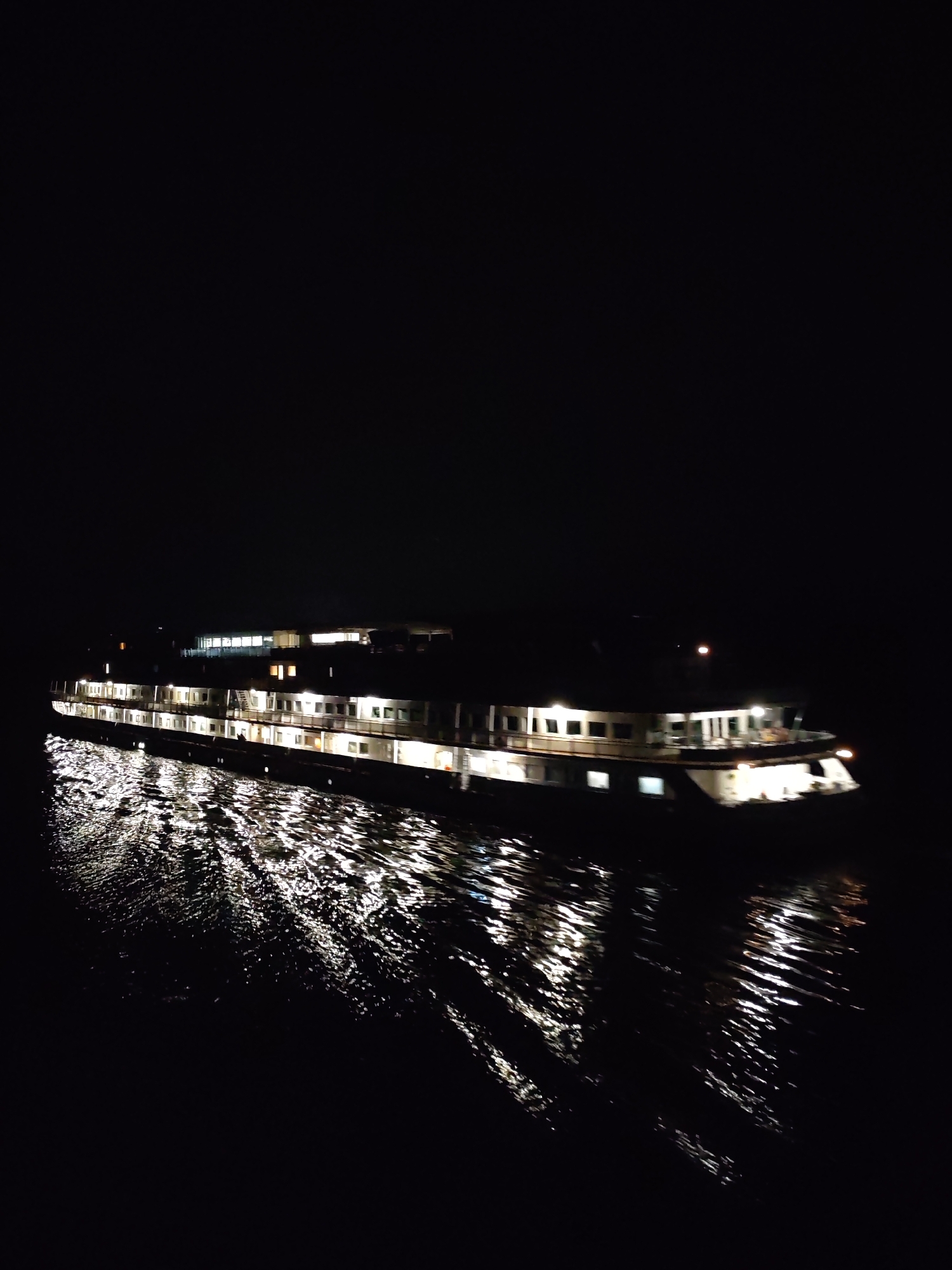 Illuminated riverboat documented operating at night by multiple witnesses
