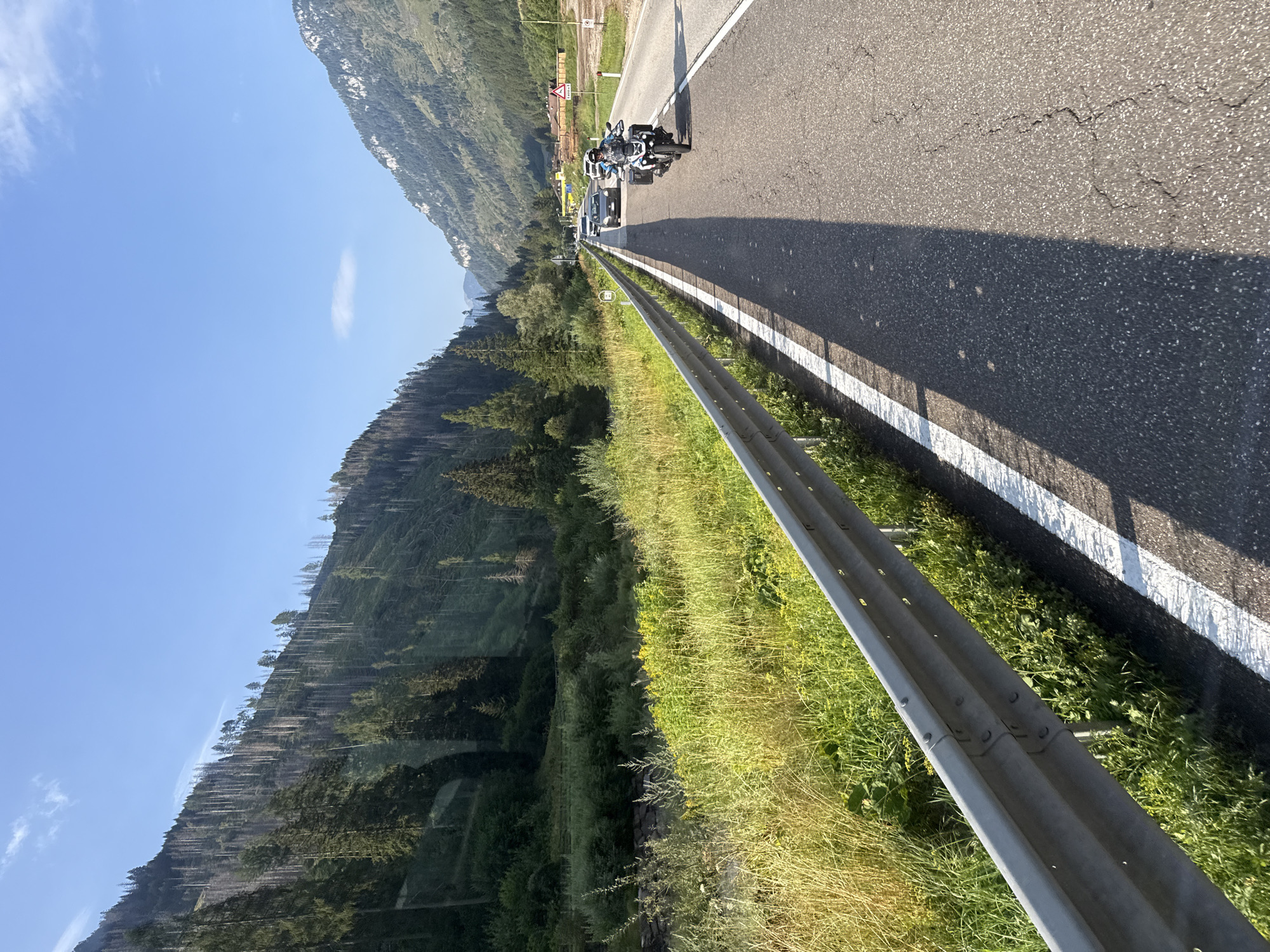 Motorcycle ride through winding Alpine roads near Predazzo