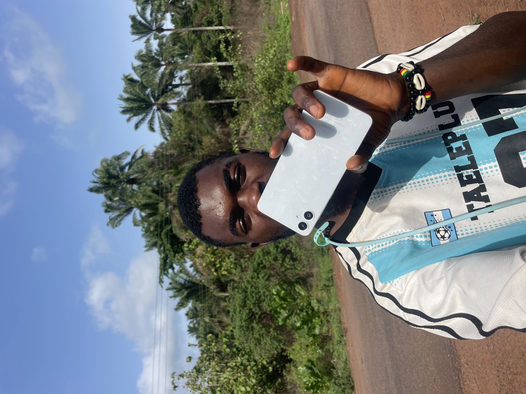 Man makes phone call, pulls goods cart on Ogbe road