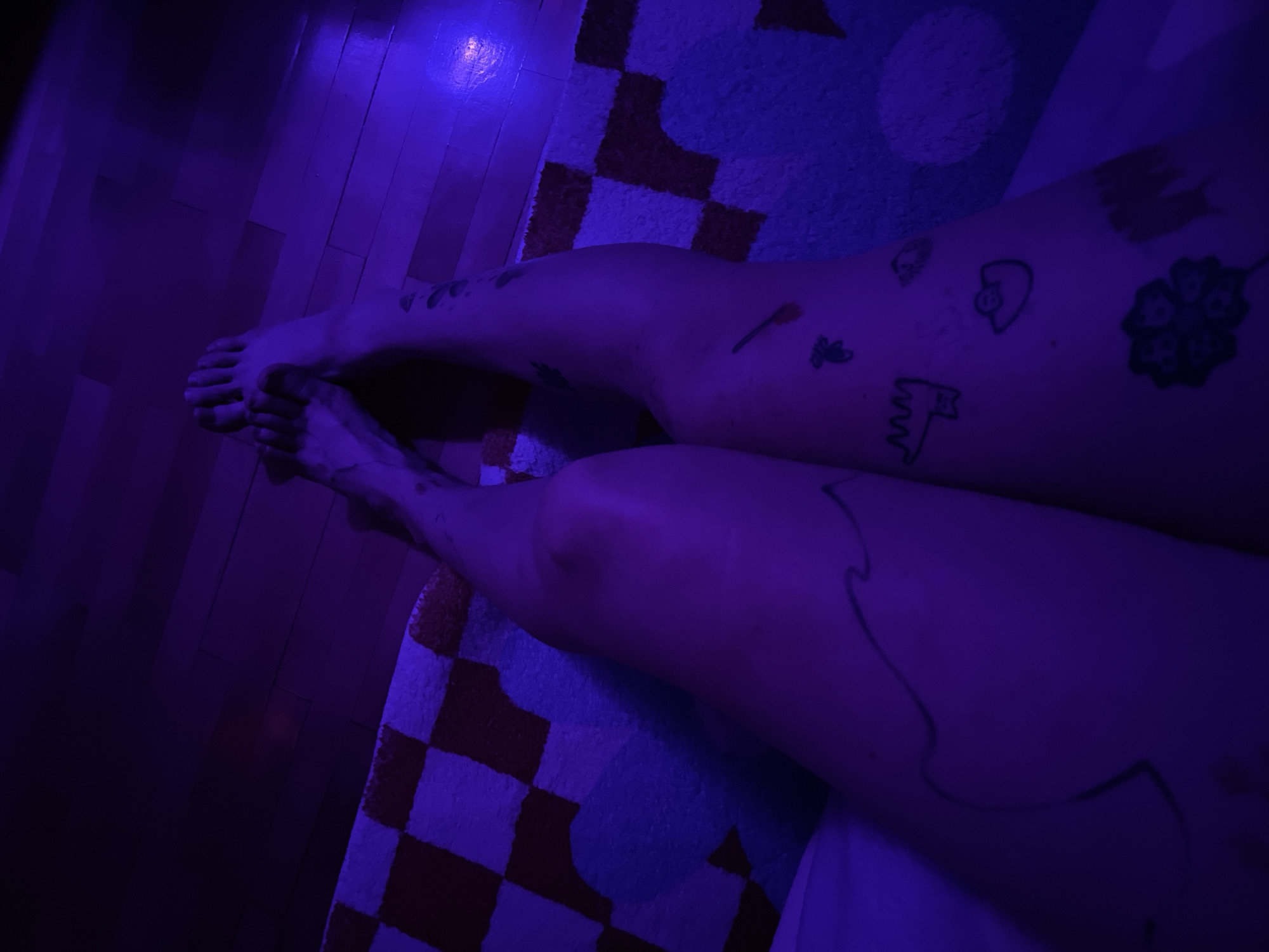 Person relaxes in colorfully lit Belgrade bedroom with artwork