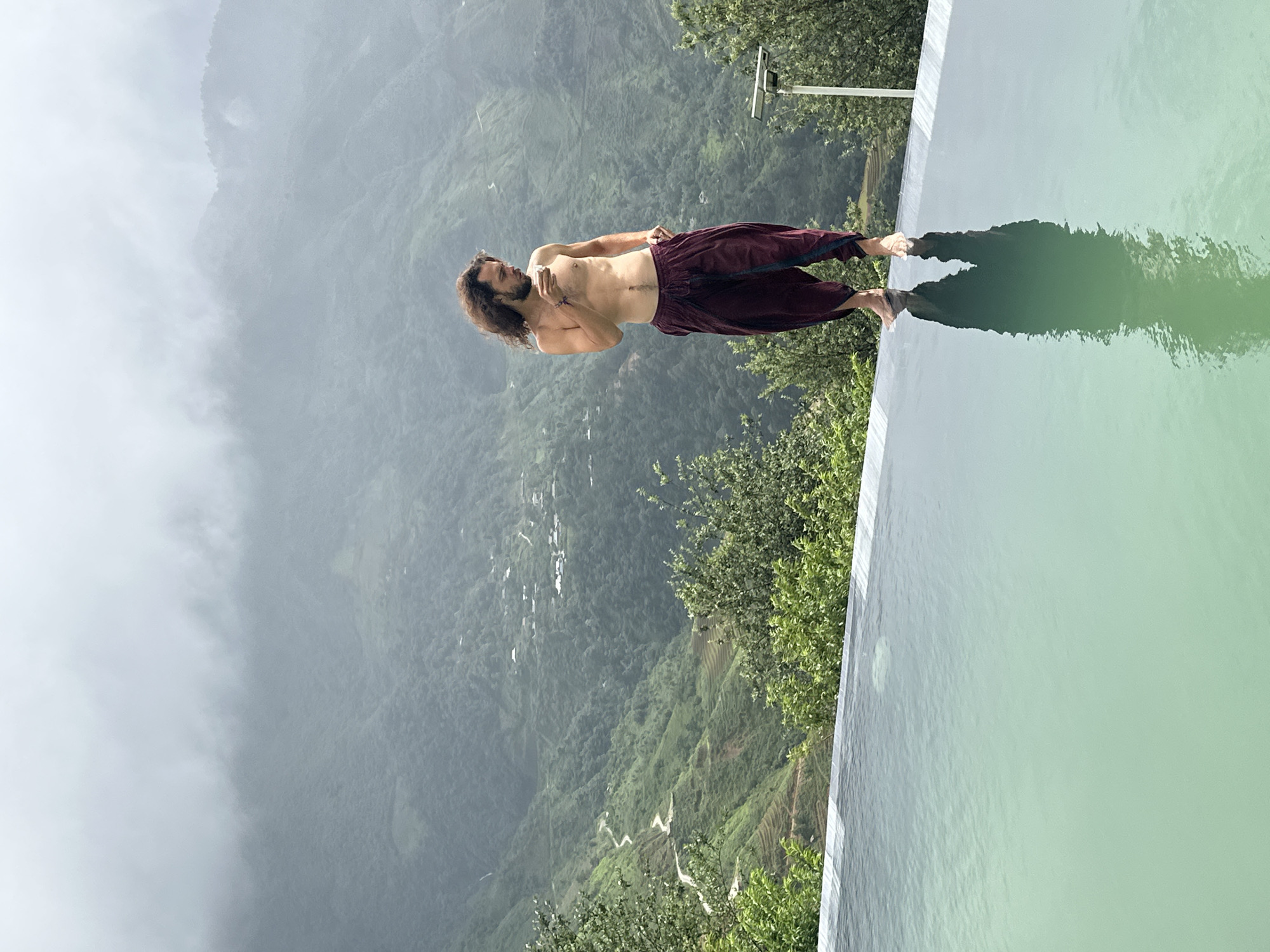 Man stands at infinity pool edge in Ta Xua