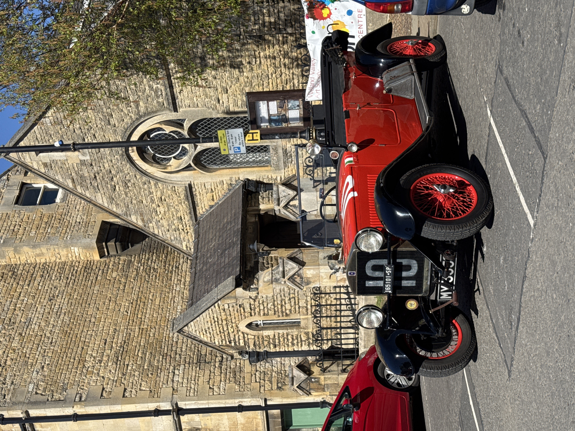 Vintage open-top car spotted near historic building in South Kesteven