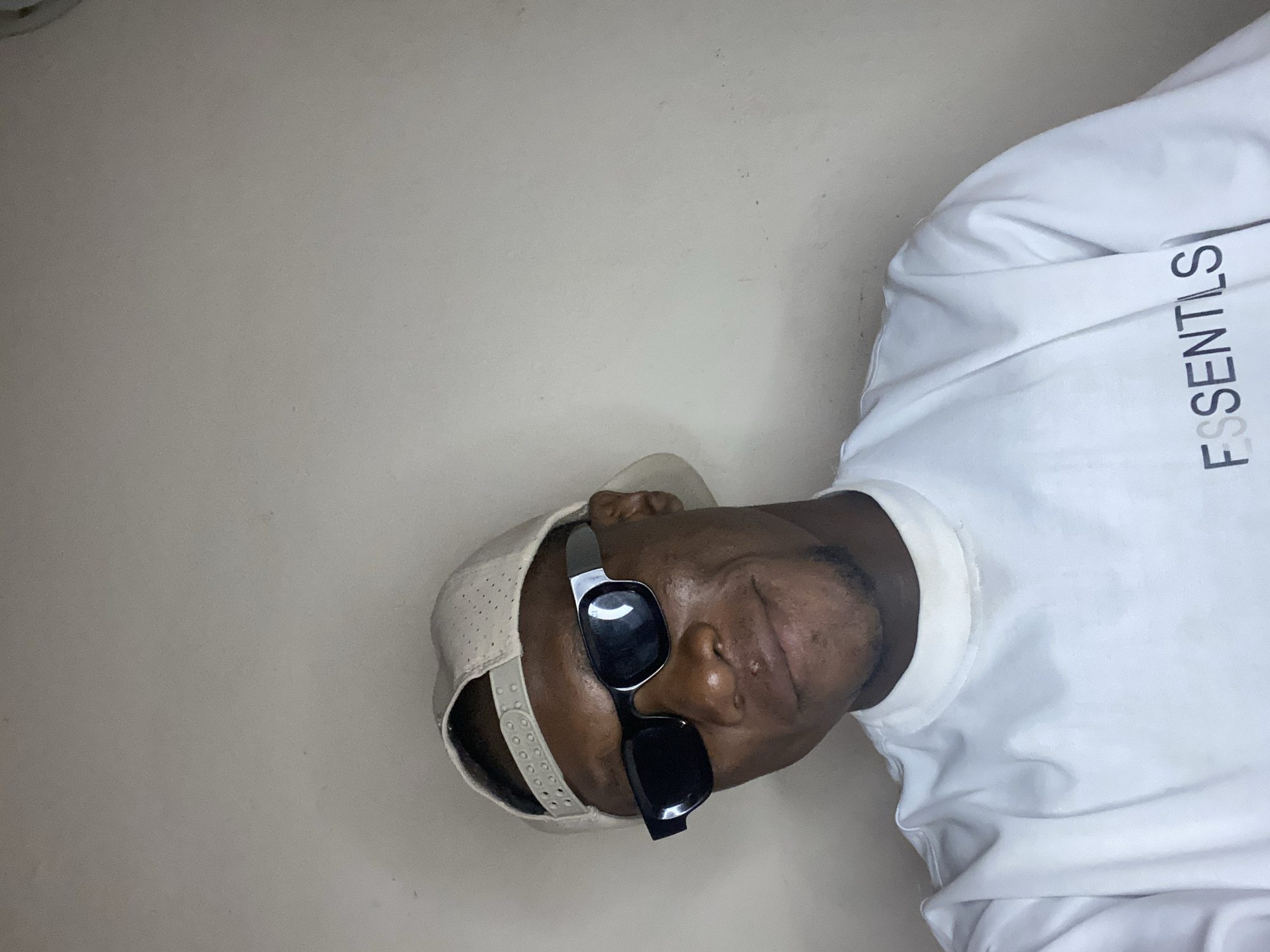 Man photographed in multiple poses wearing sunglasses in Bukuru