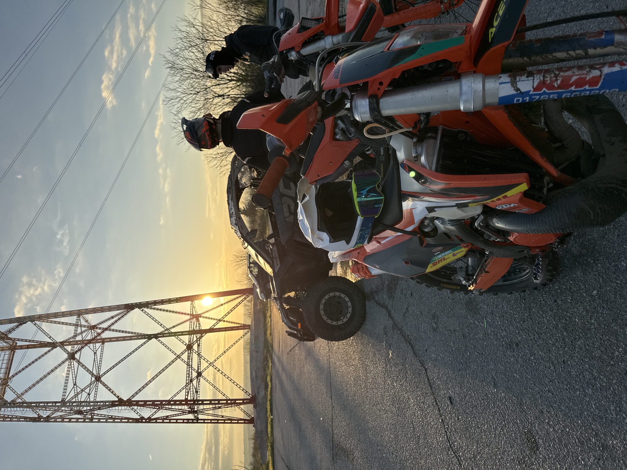 Off-road enthusiasts gather near Bulgarian pylon during sunset