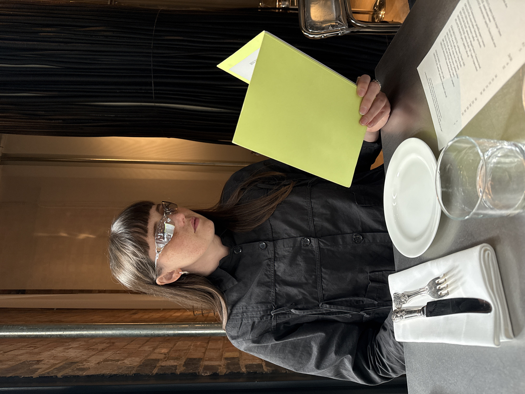 Diner reviews menus at London restaurant