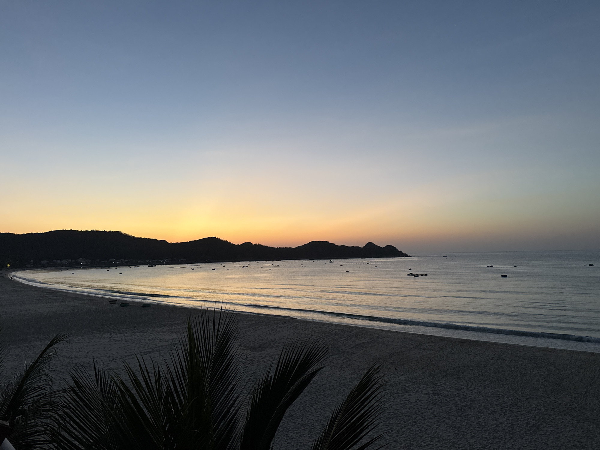 Coastal dawn, sky gradients and silhouetted hills