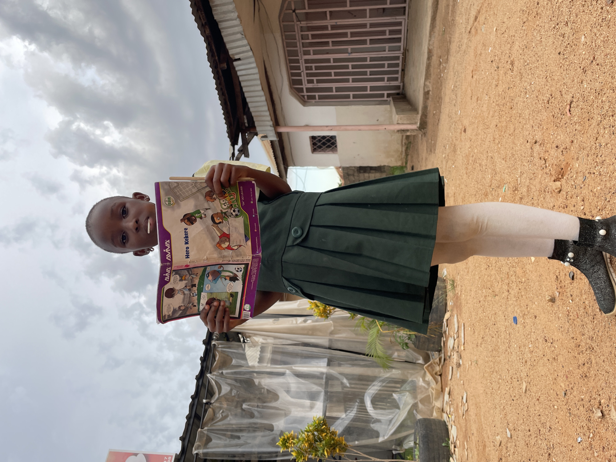 Daily life unfolds in Jos streets: schoolchildren, vendors, motorcycles