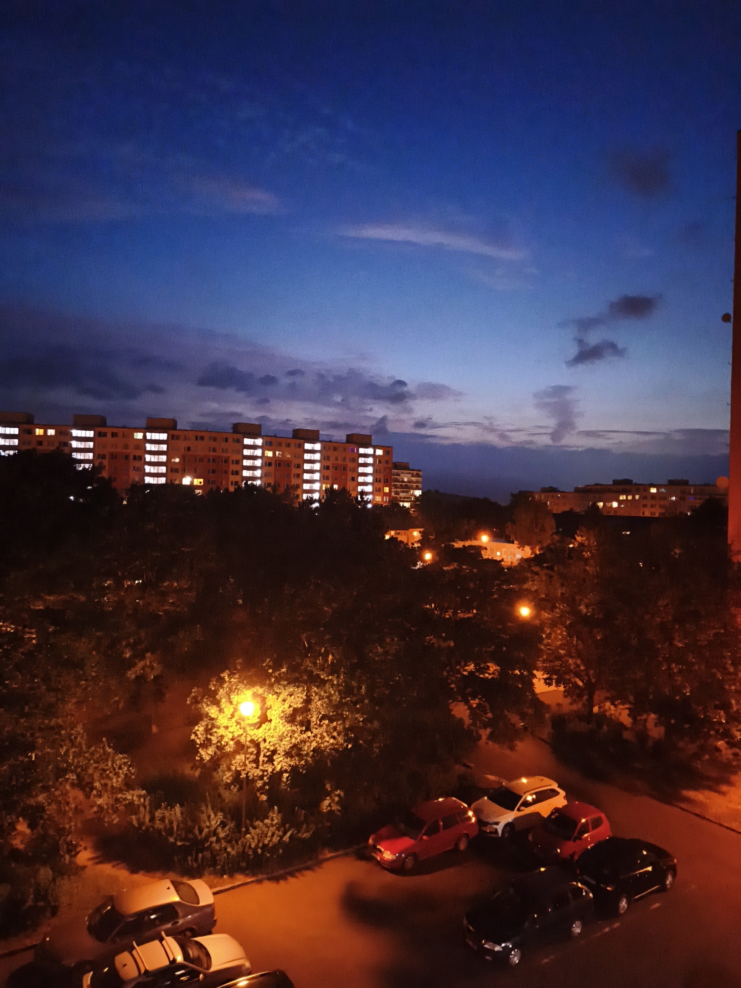 Dusk falls over Most's apartment blocks, with quiet moments inside