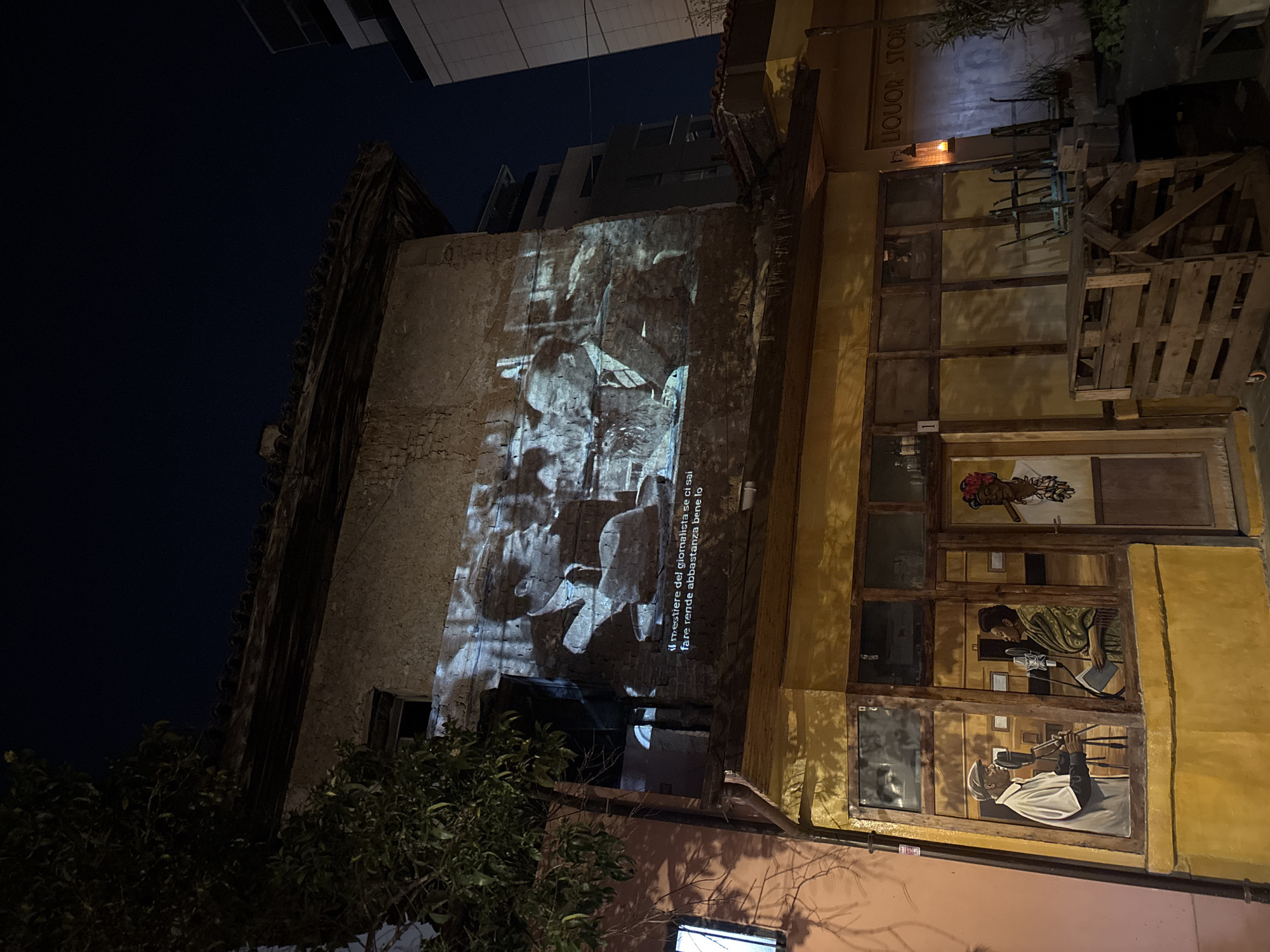 Traditional drummer performs in Tirana square near colorful mural