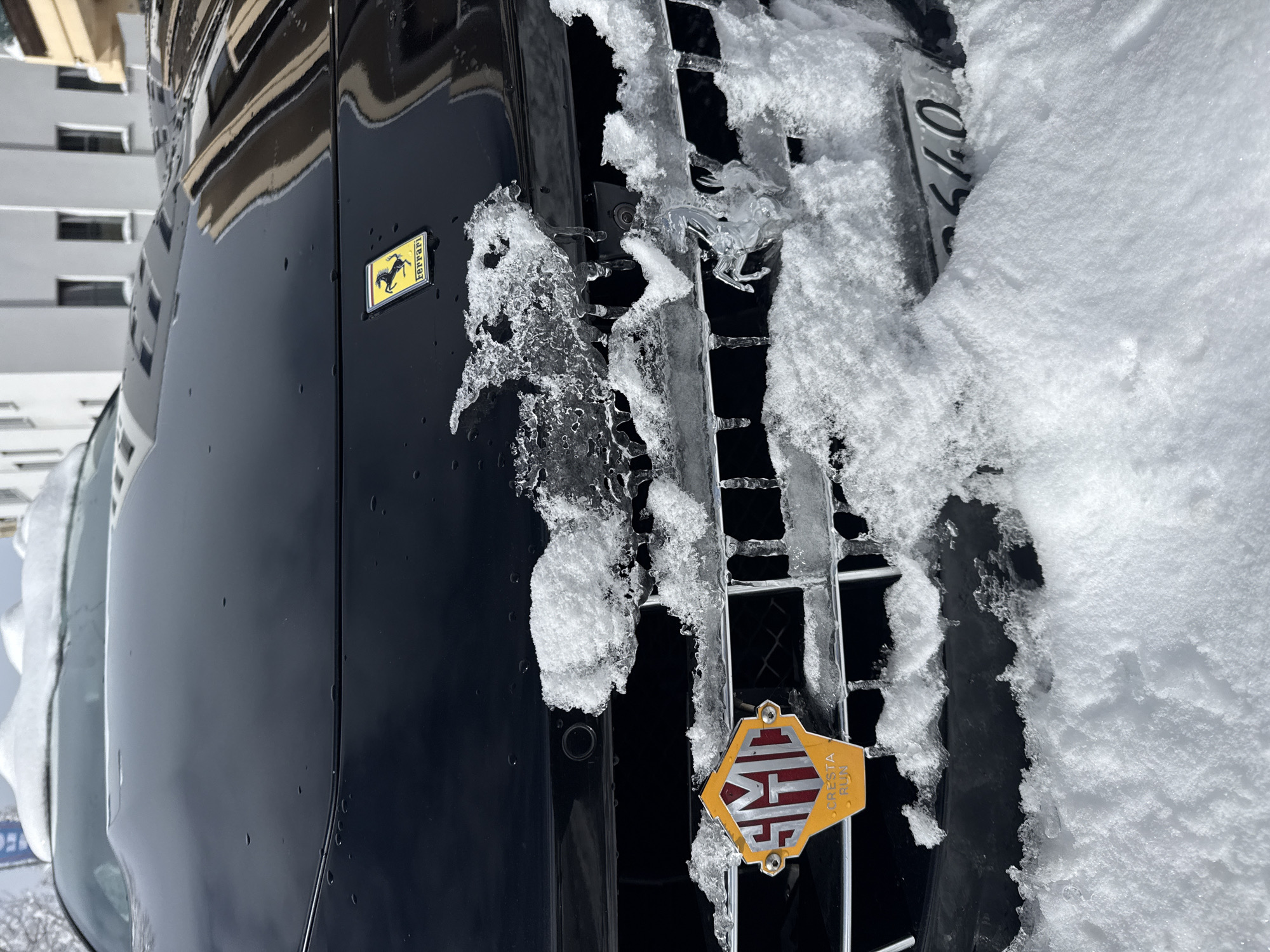 Snow-covered Ferrari spotted parked in Sankt Moritz winter street