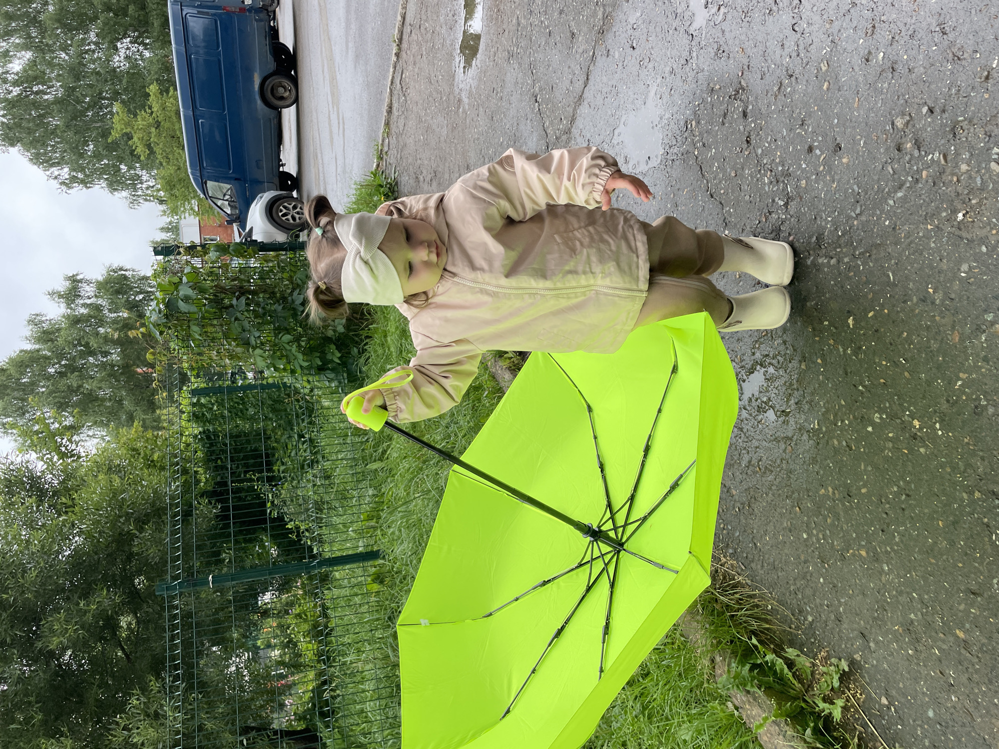 Rainy day in Izhevsk with a lime green umbrella