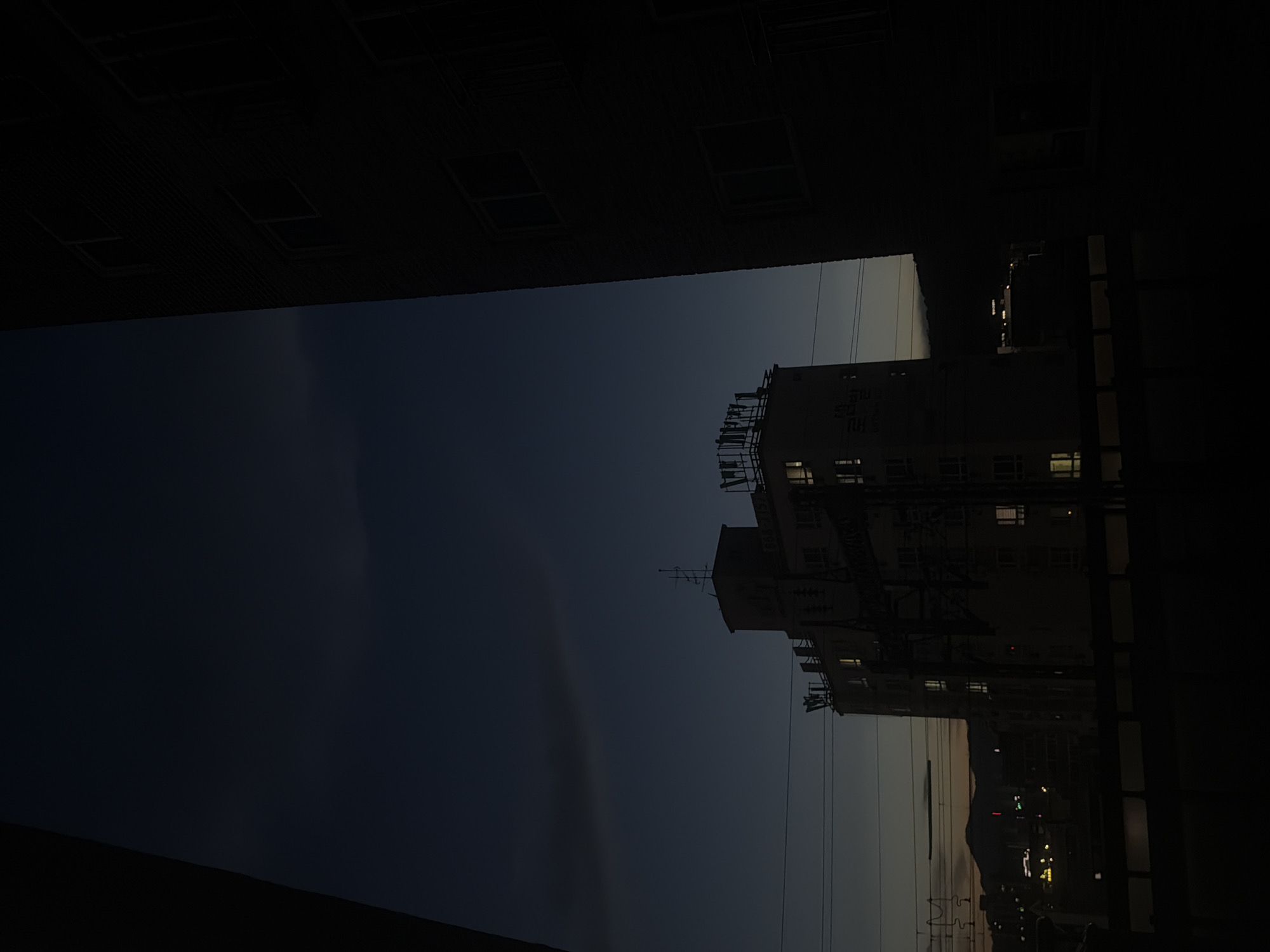 Dusk settles over residential Dongducheon, a lit window draws the eye
