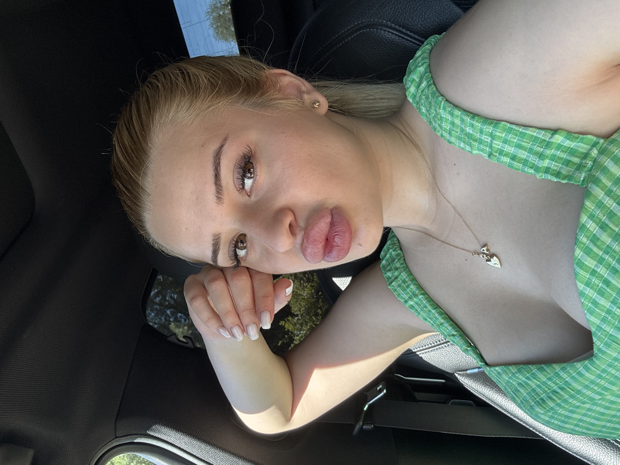 Woman in green plaid observed in car, Byala Slatina