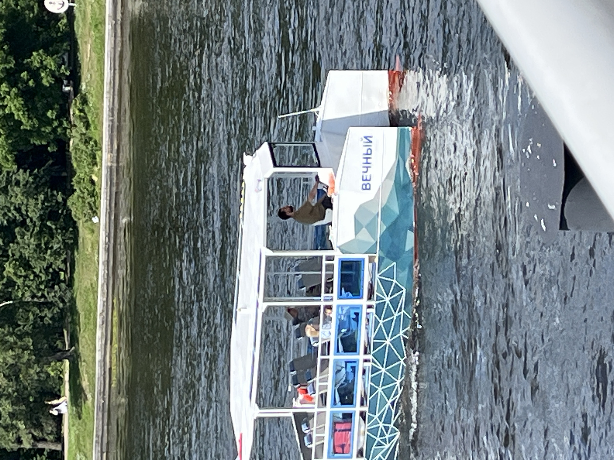 Sunny morning on the Neva River, passenger boats in motion