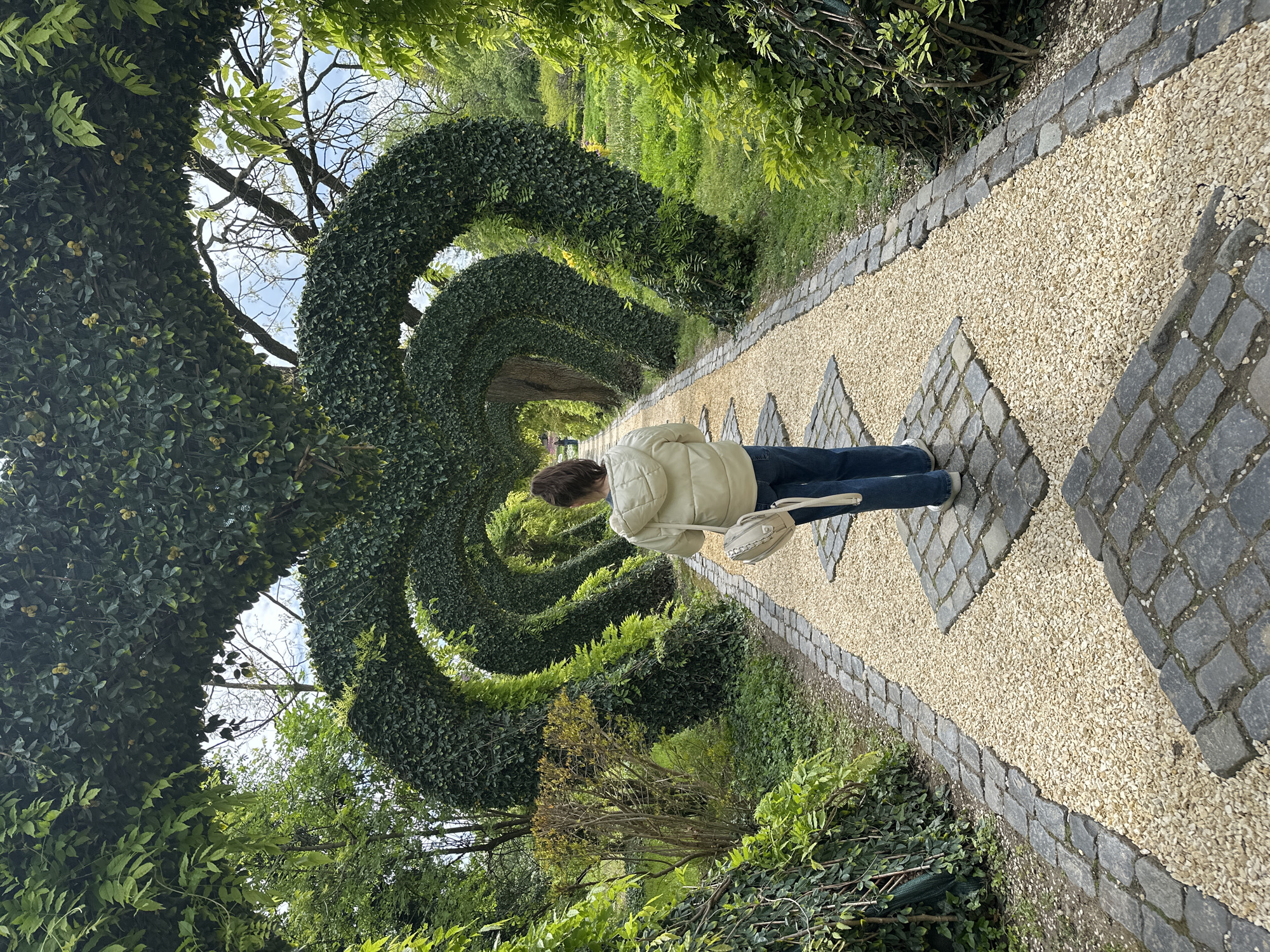 Woman walks through hedge tunnel at Romanian park
