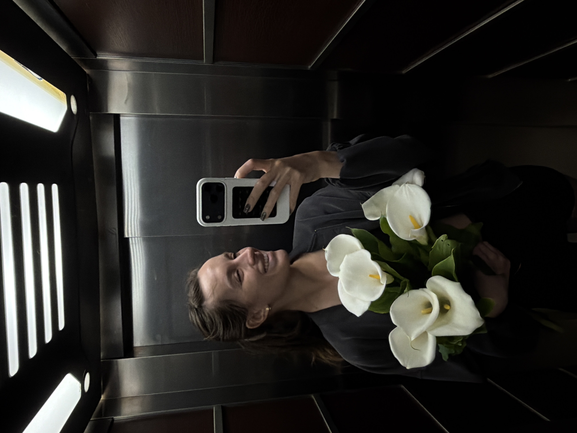 Woman takes elevator selfie with flowers in Budva