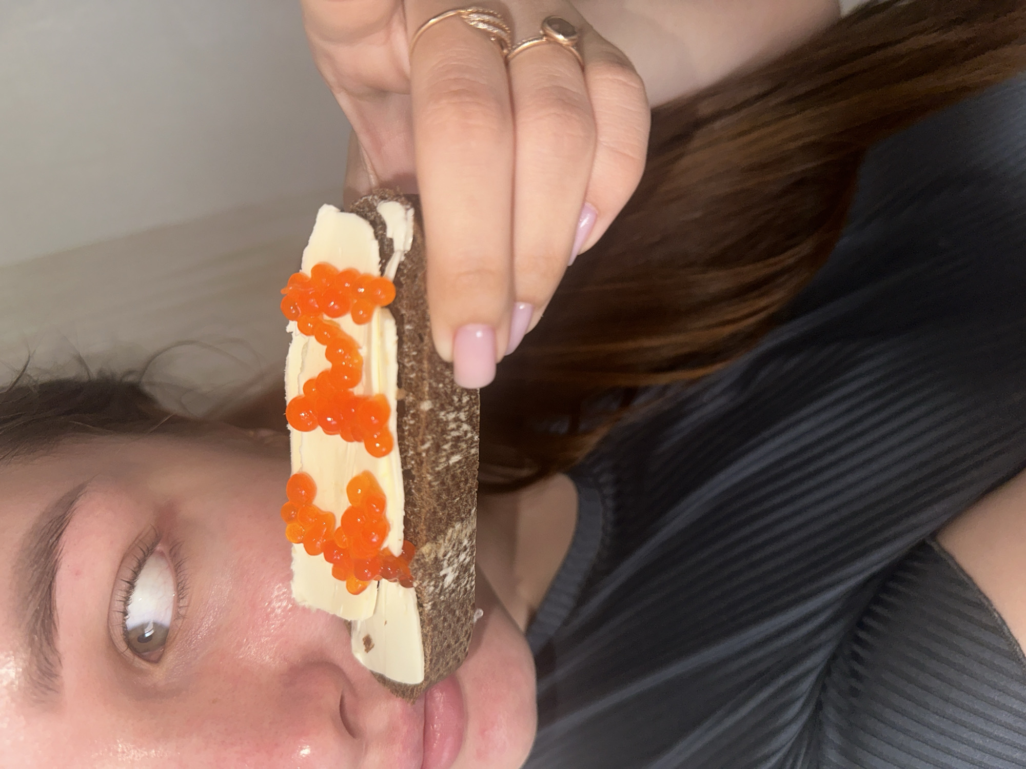 Woman enjoys caviar toast breakfast in Chaikovsky, Russia