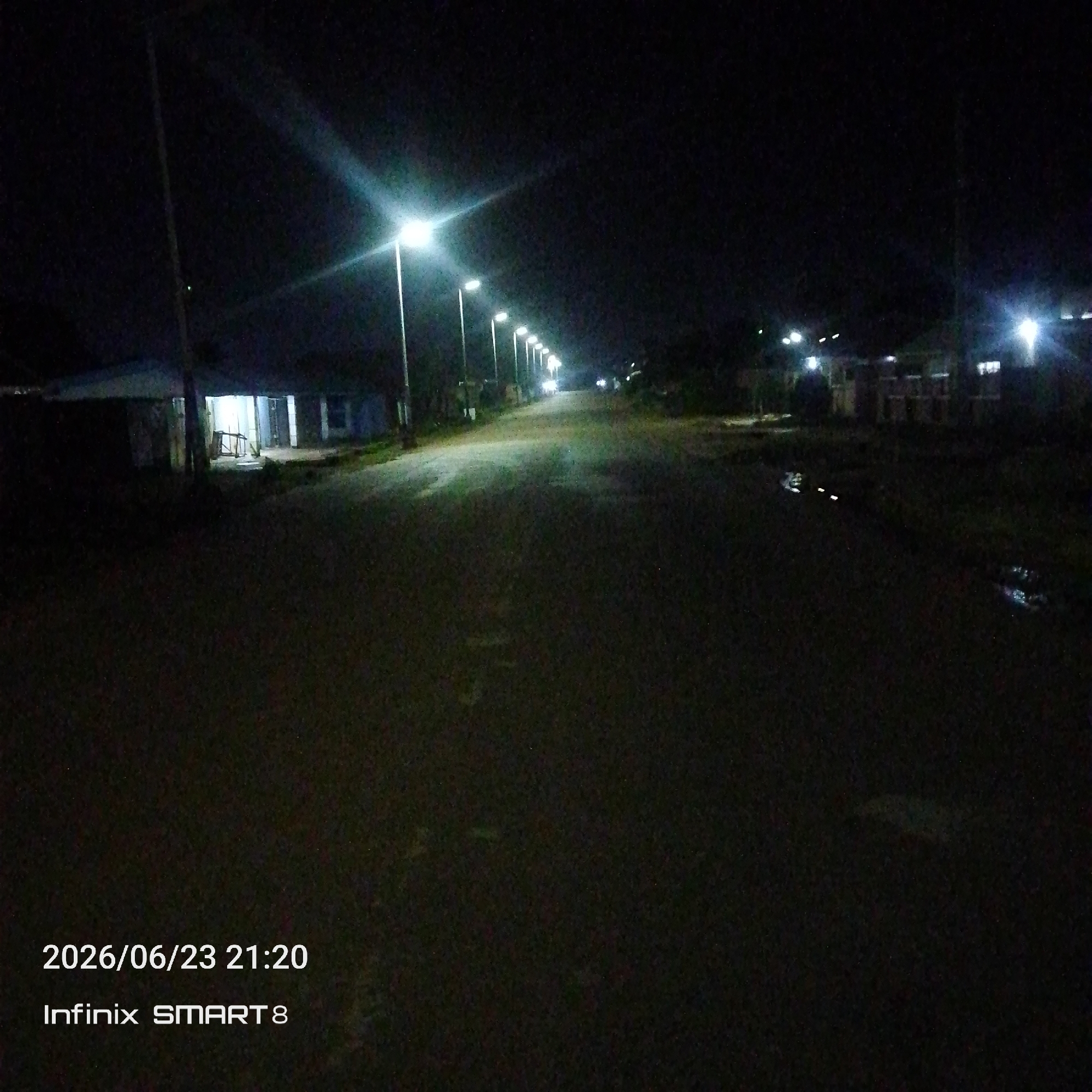 Quiet nighttime street in Jos, Nigeria, under streetlights