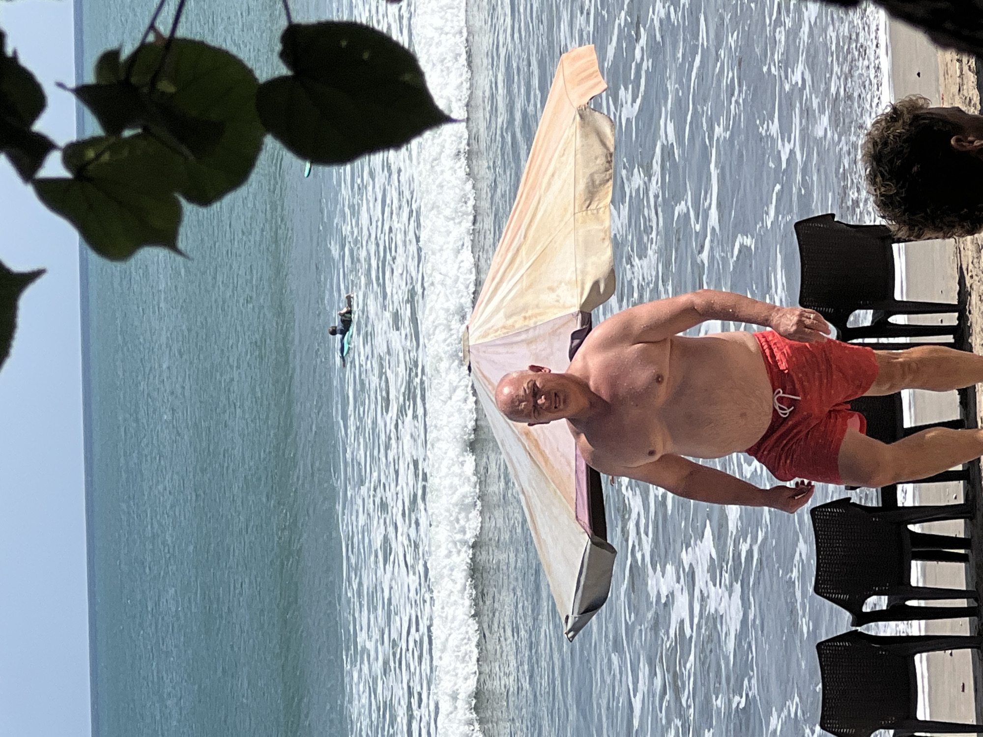 A busy morning at Kuta Beach with surfers and beachgoers