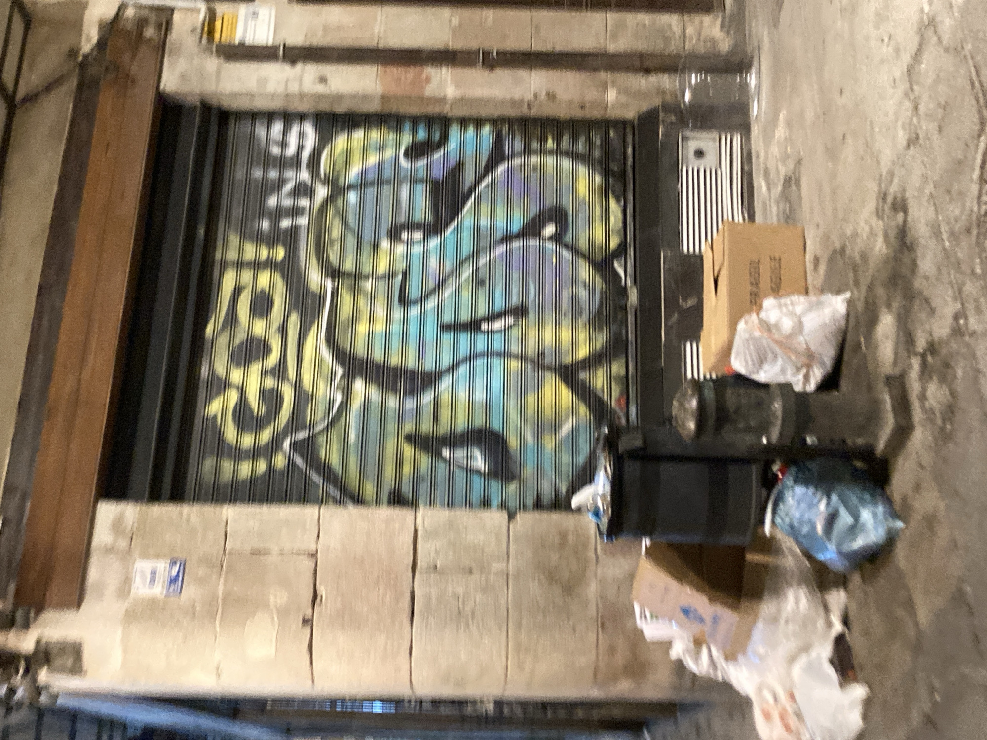 Barcelona's Gothic Quarter at night, shutters down and graffiti up