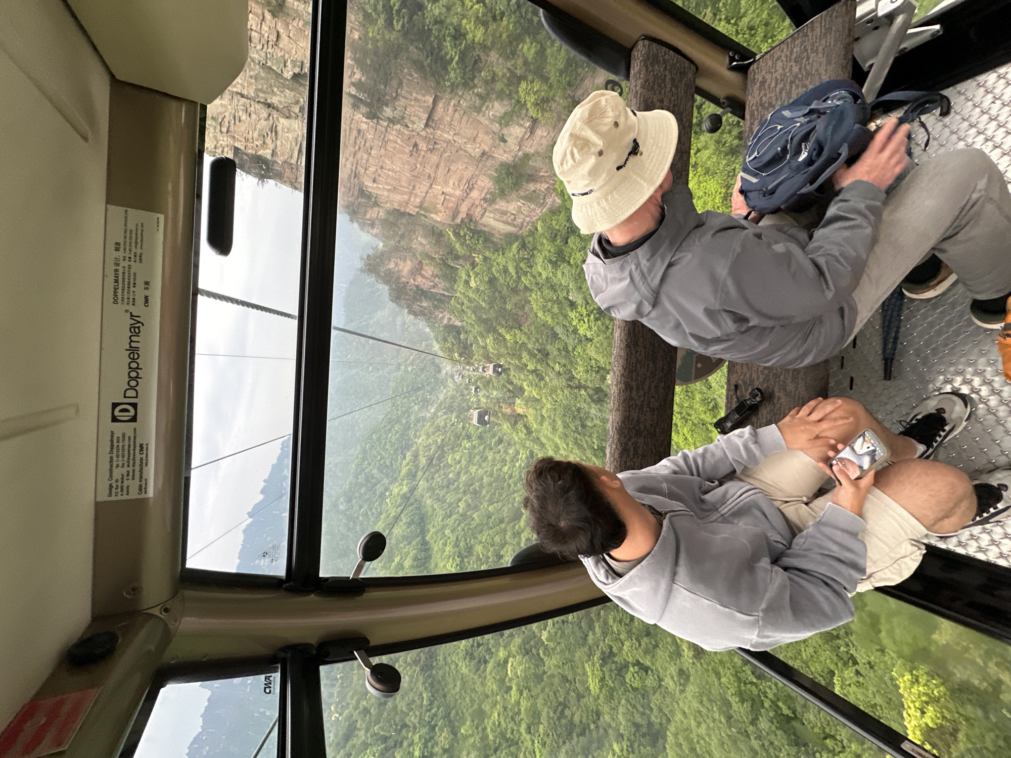 Cable car riders view Wulingyuan's sandstone pillars in China