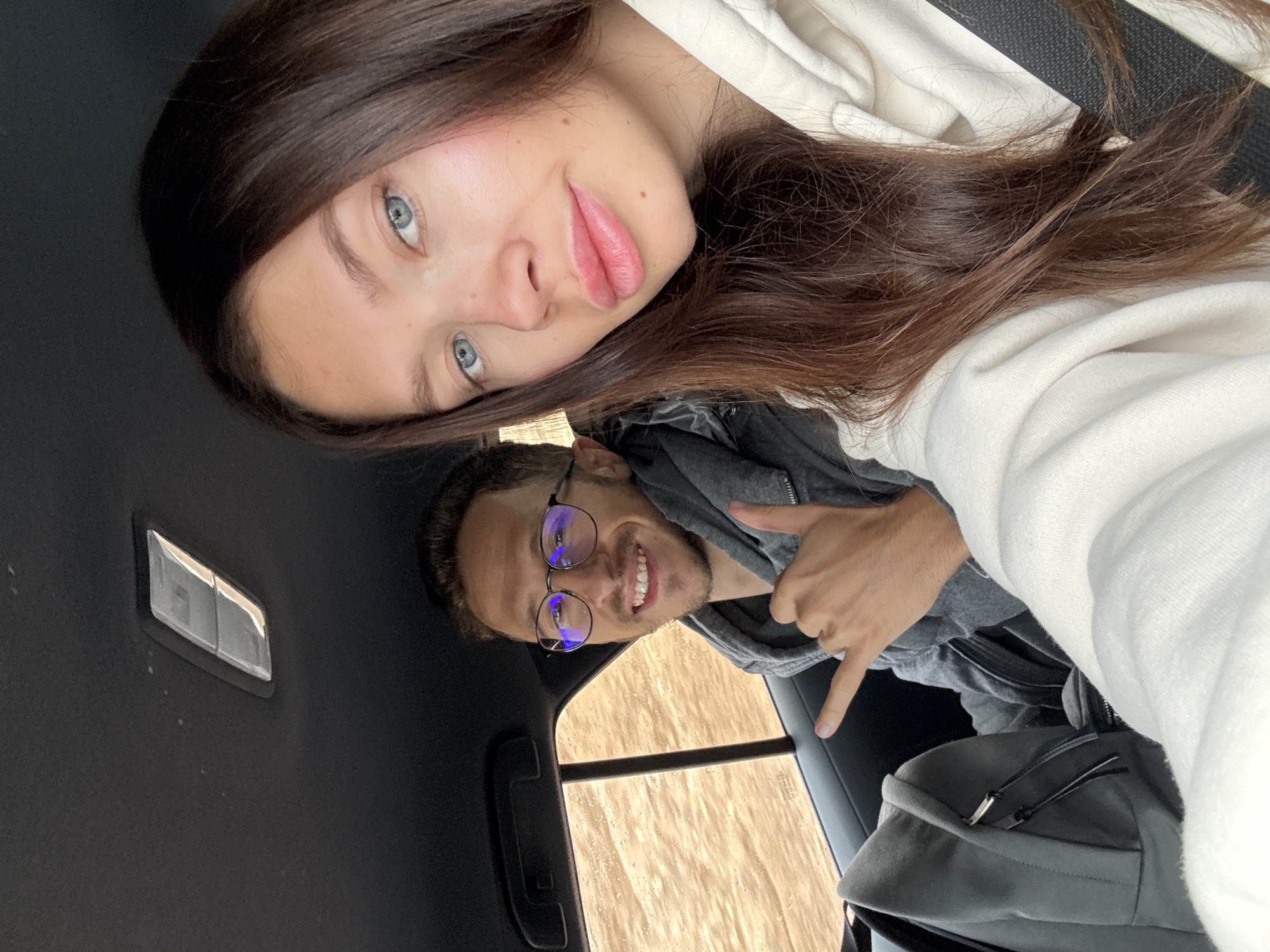 Travelers take selfie while driving through Eilat Mountains desert