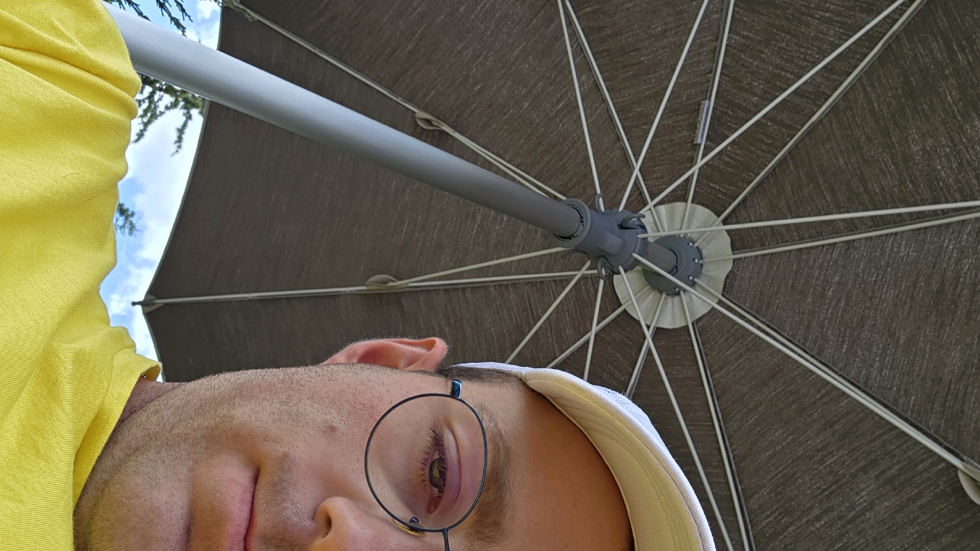 Low-angle umbrella shots frame a figure from below
