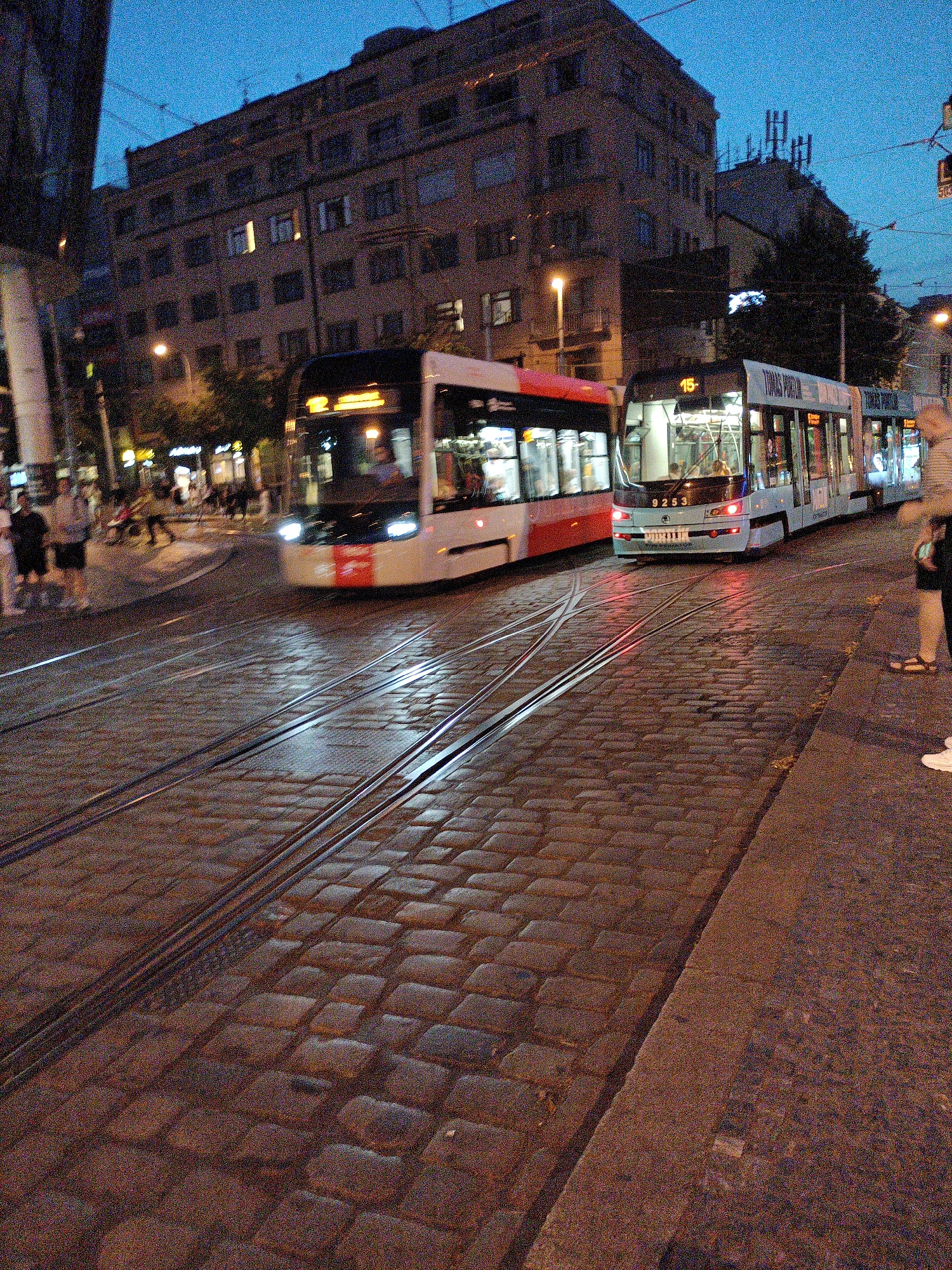 Prague trams rolling through cobblestone streets at dusk