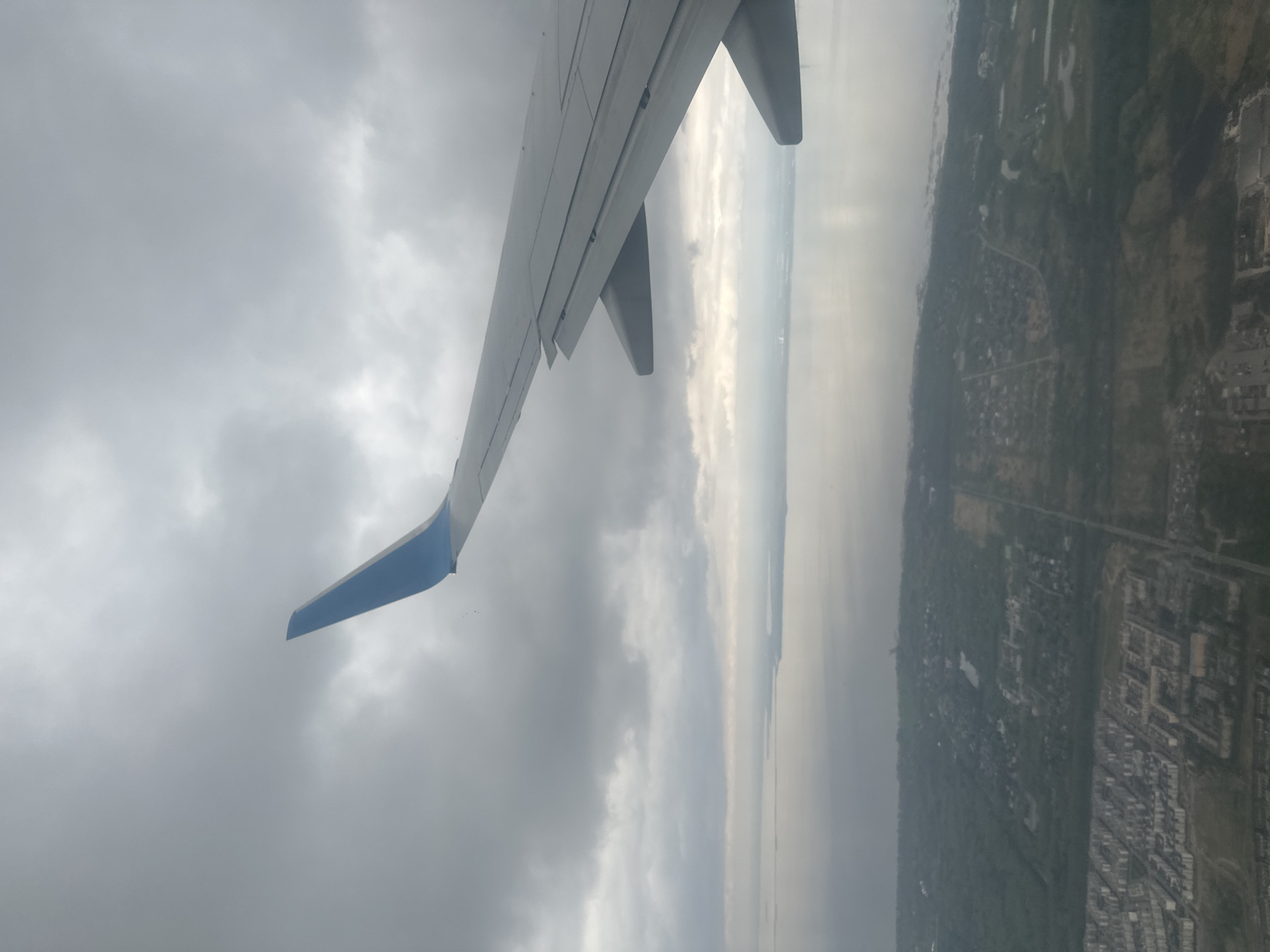 Passenger documents aerial view of coastal Russian city from airplane