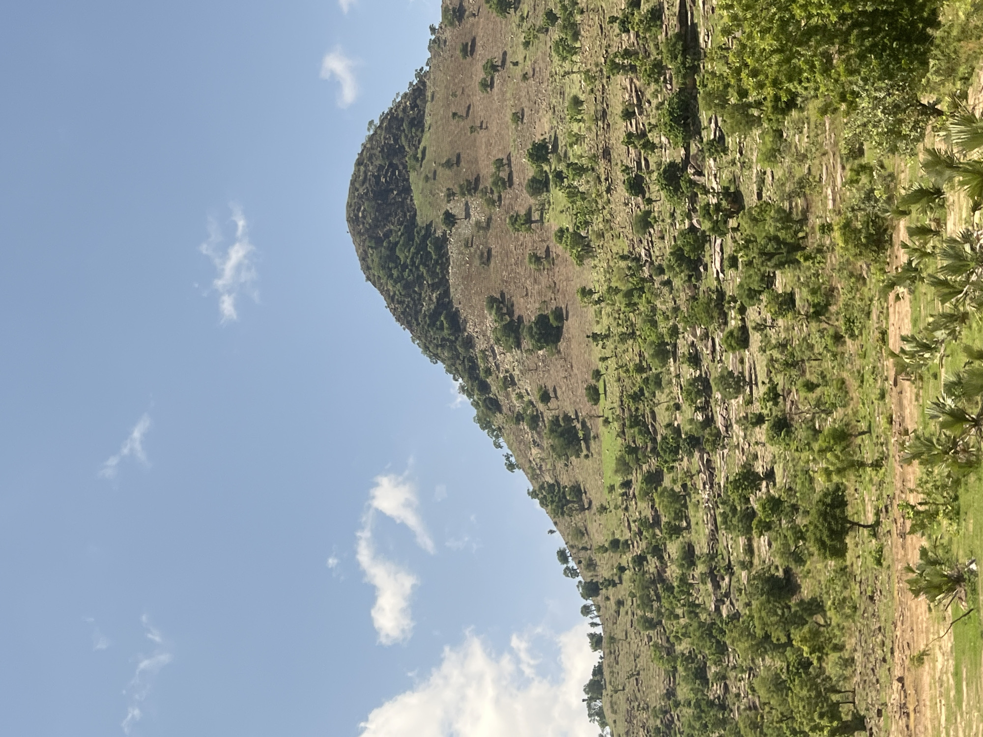 Conical hill photographed in sunlit Balanga, Nigeria landscape
