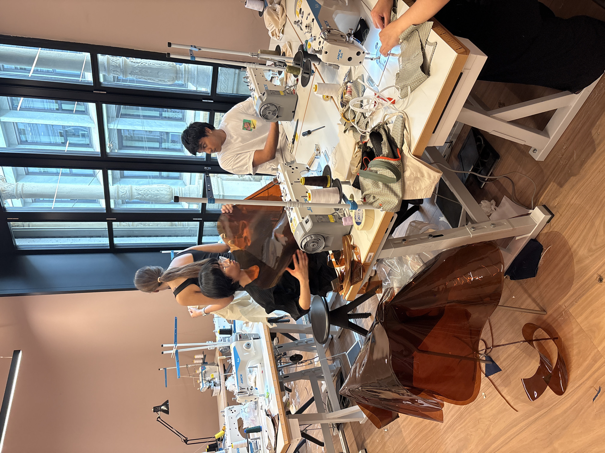 Fashion designer works in Milan studio, celebrates with cake