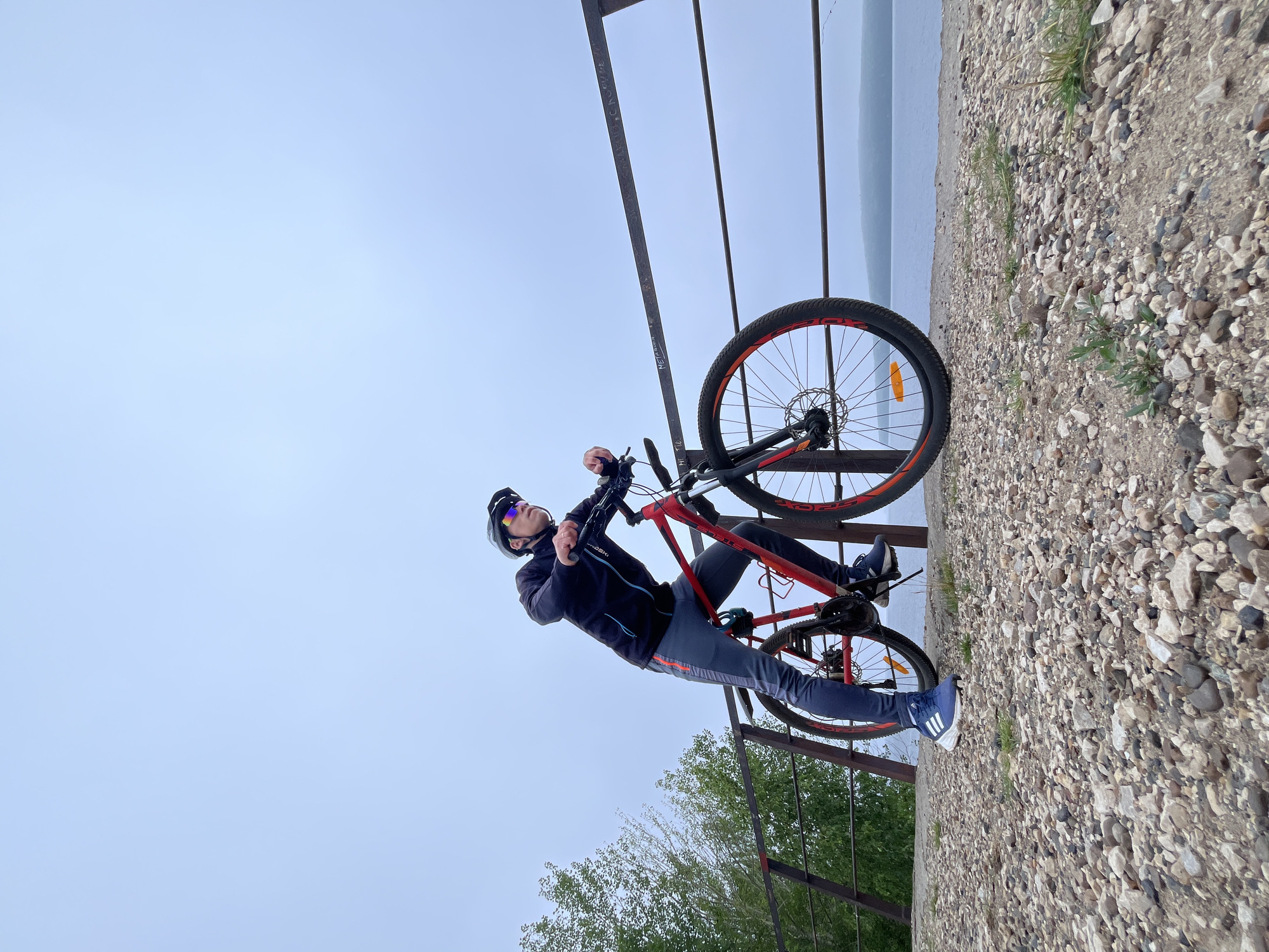 Solo cyclist rides the Kama River embankment in Chaikovsky