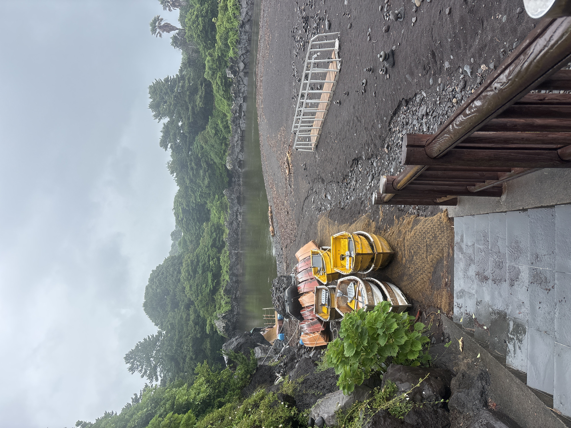 Rainy day along Seogwipo's volcanic coastline and black sand beaches
